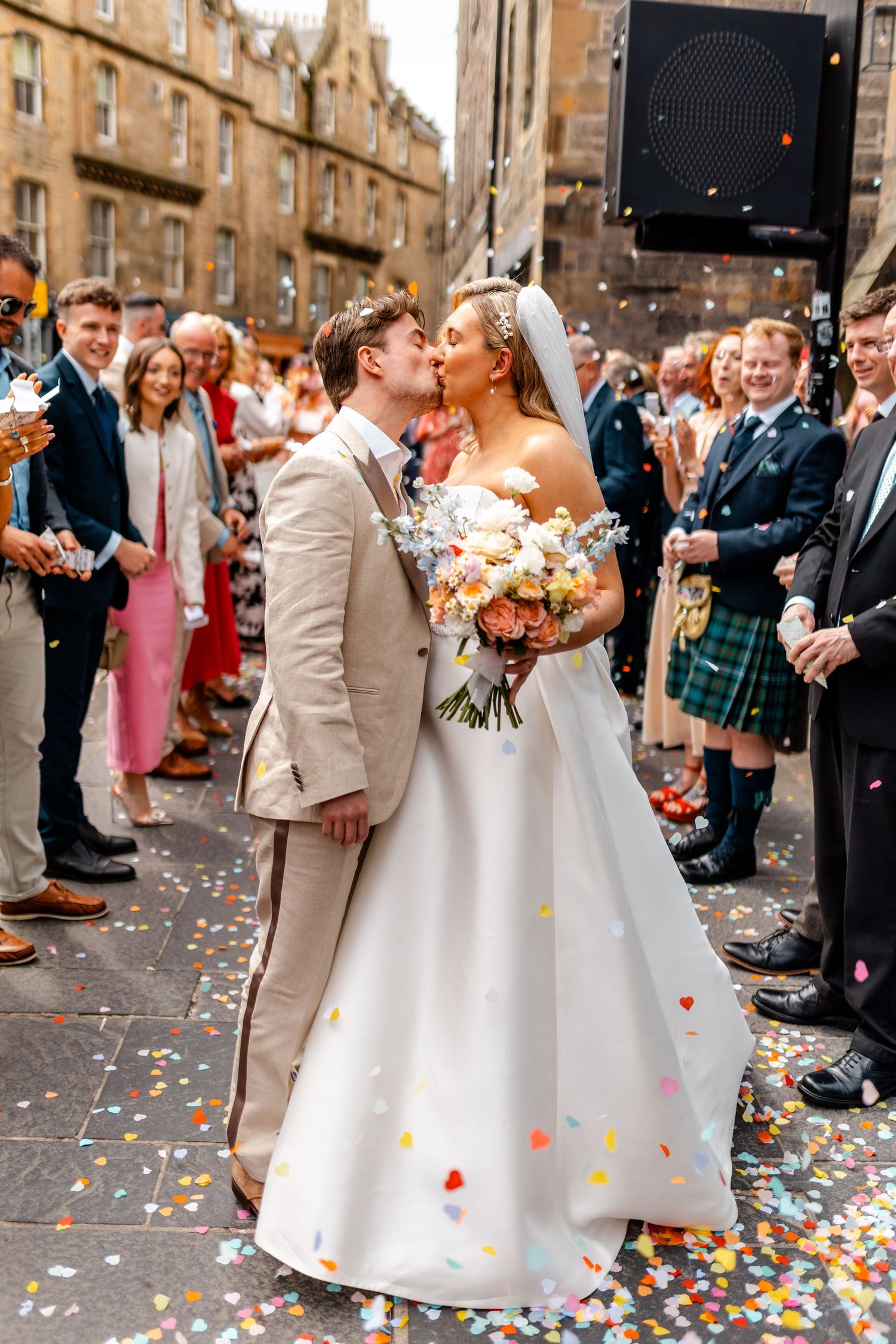 Wedding bride and groom kissing, confetti, Virgin hotel in Edinburgh City Scotland