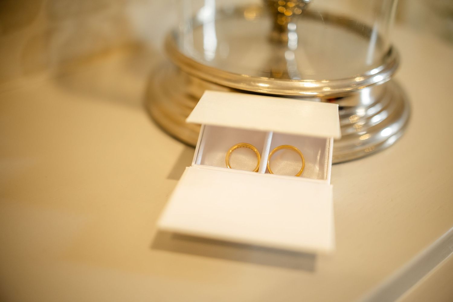 Close up of elegant place settings with gold accents in warm lighting.