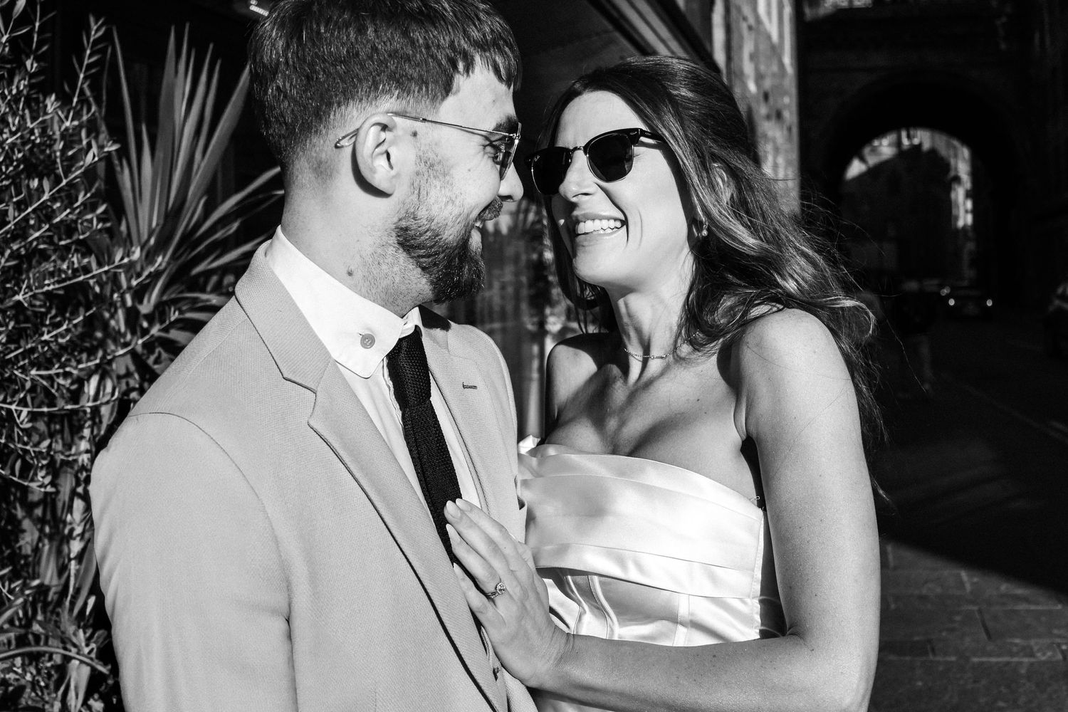 Romantic black and white portrait of a couple sharing an intimate moment outdoors.