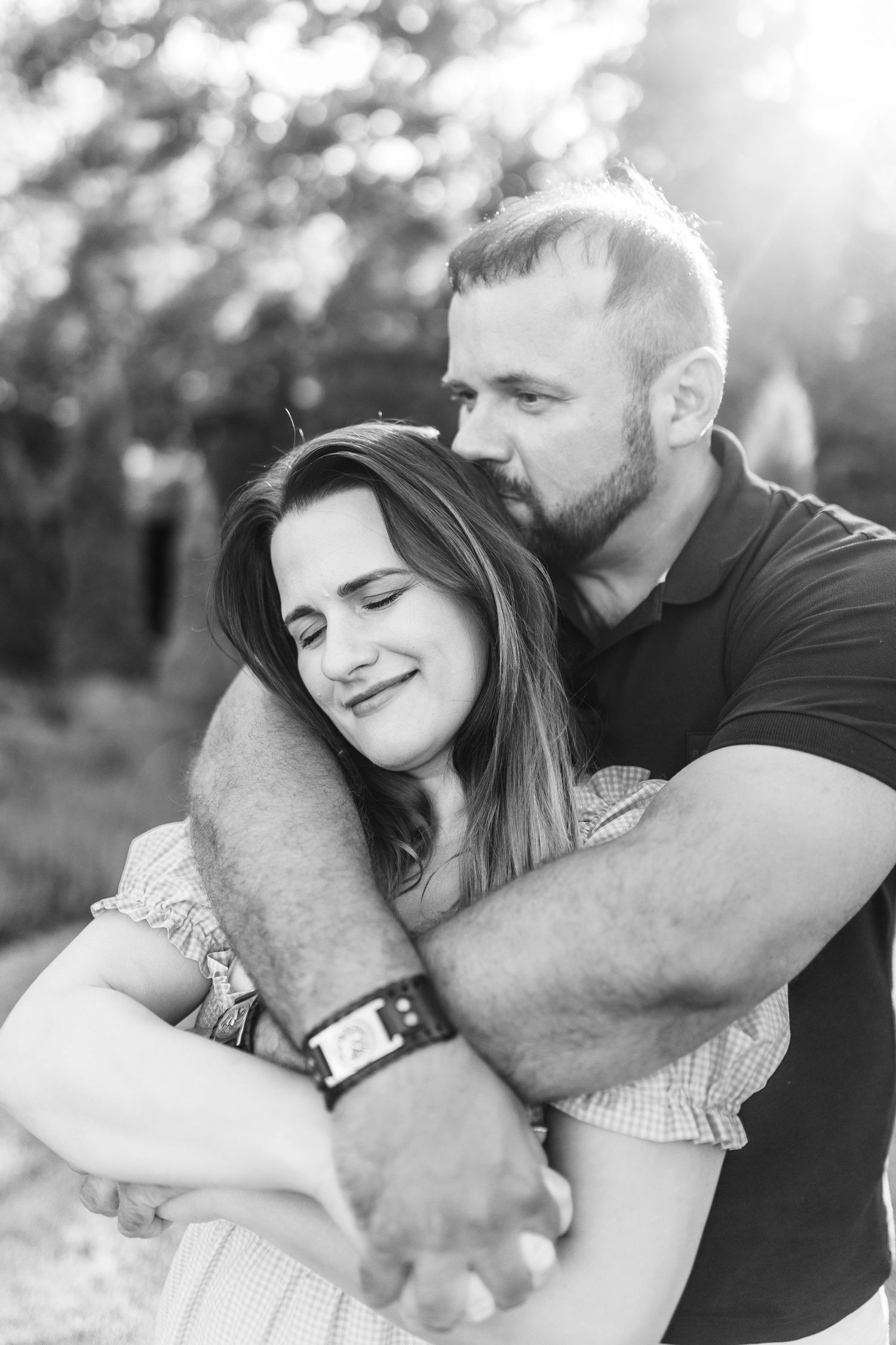 A couple shares intimate black and white moments together outdoors.