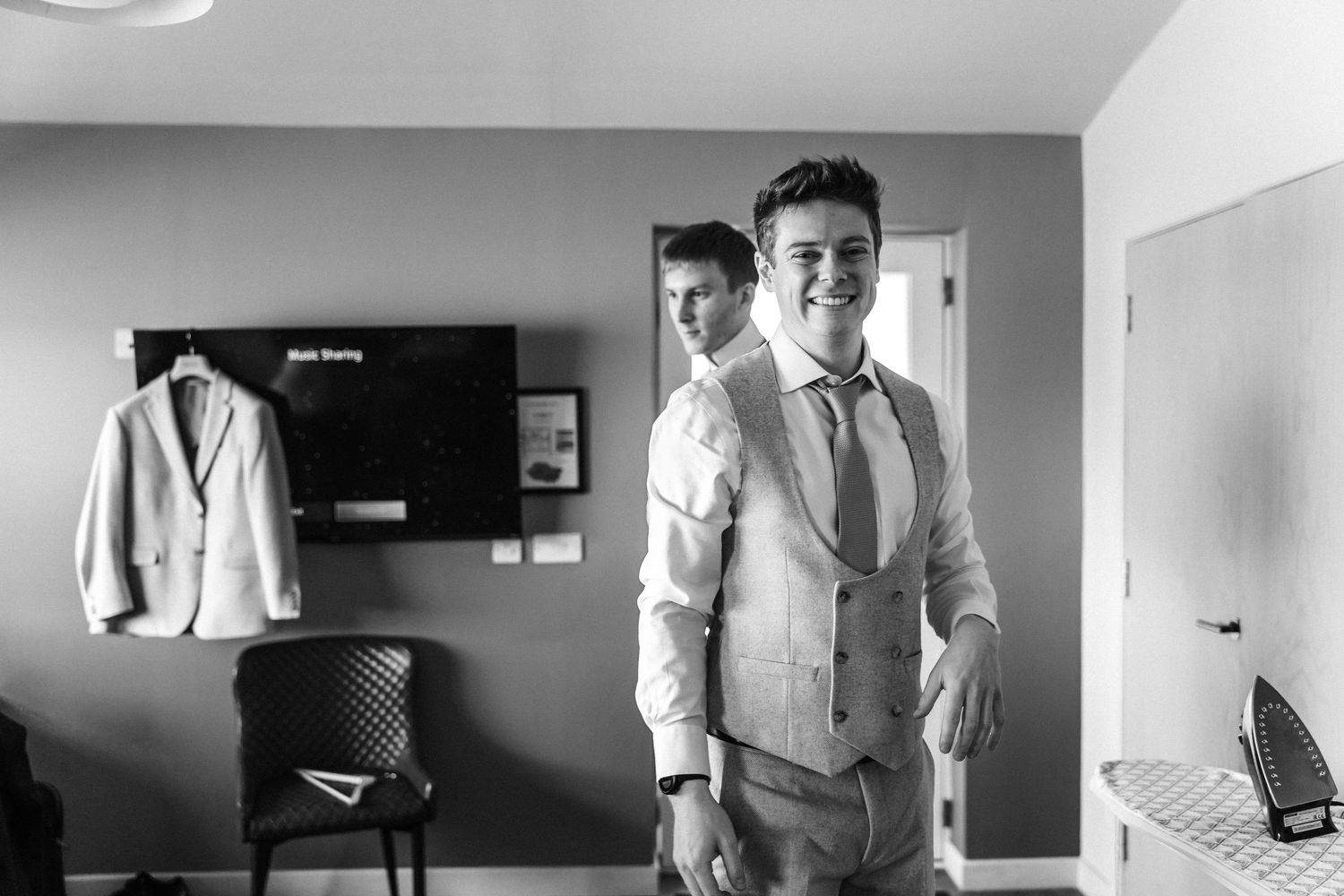 Black and white photos of formal wedding preparation moments.