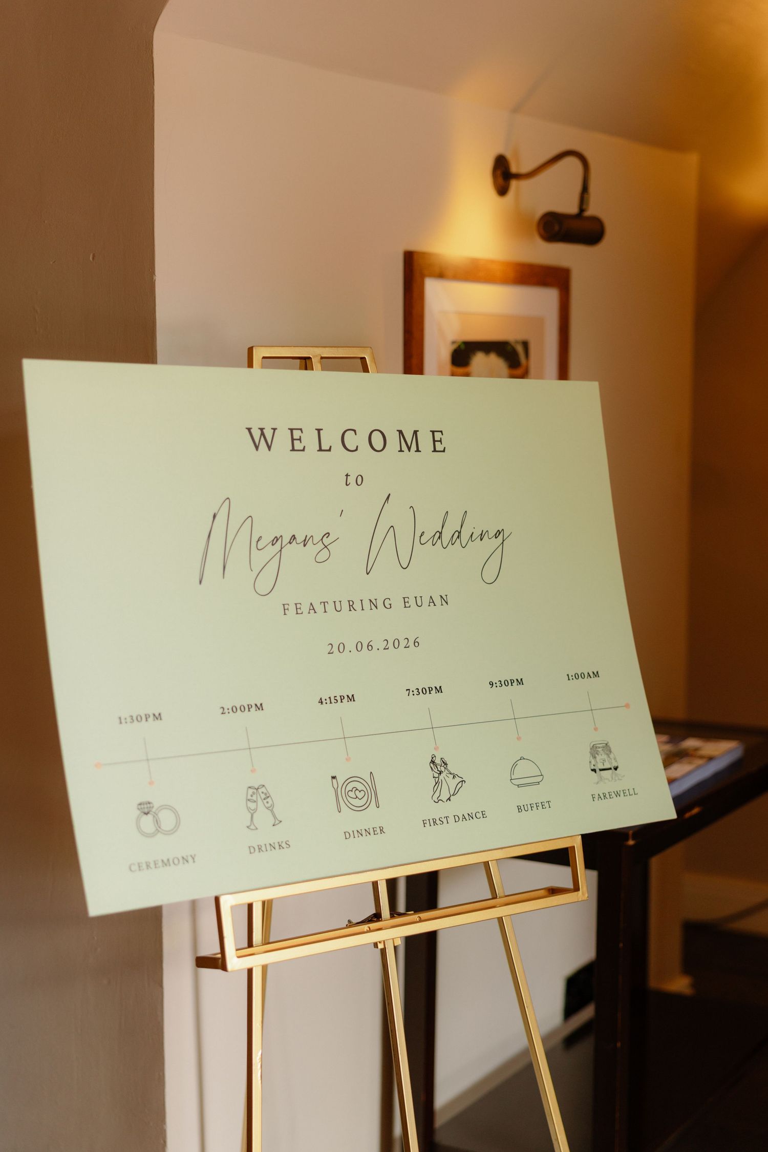 Elegant wedding welcome sign for Megan's wedding featuring Euan on June 20, 2026, displayed on a gold easel.