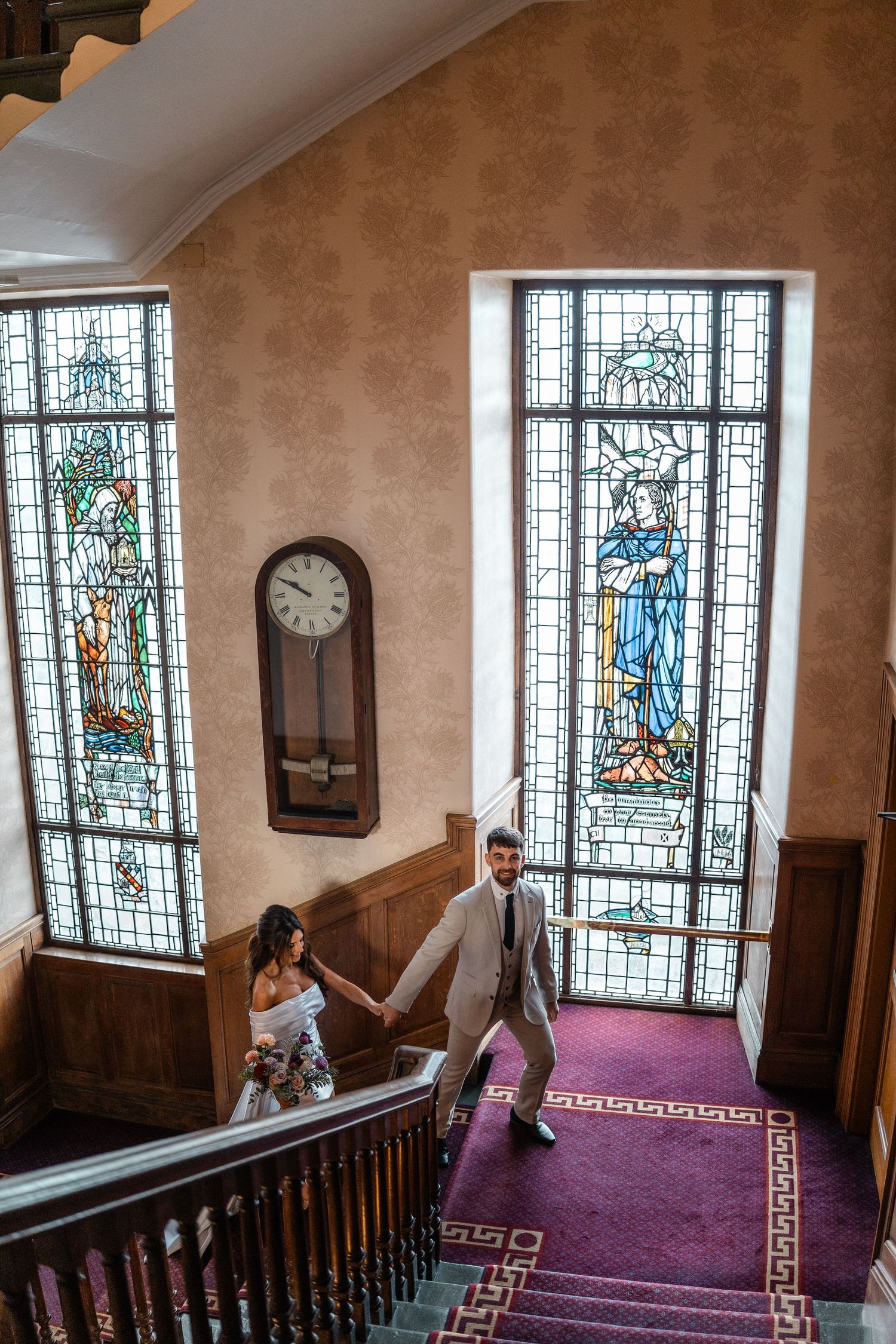 Historic church interior with beautiful stained glass windows and purple carpeted stairs.