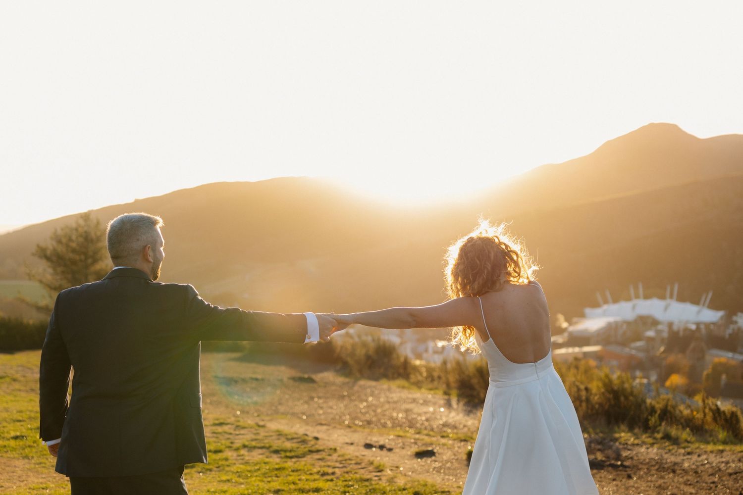 Golden sunset silhouette sequence of couple in a mountainous landscape.