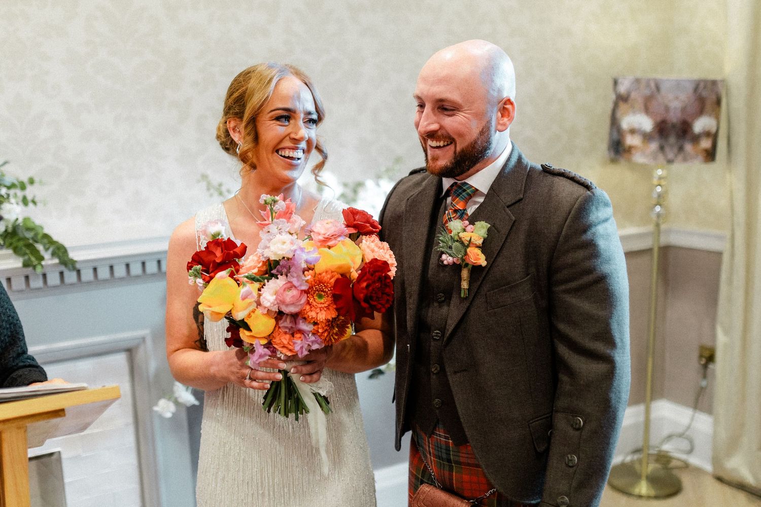 Candid wedding moments captured in sequence outside stone building.