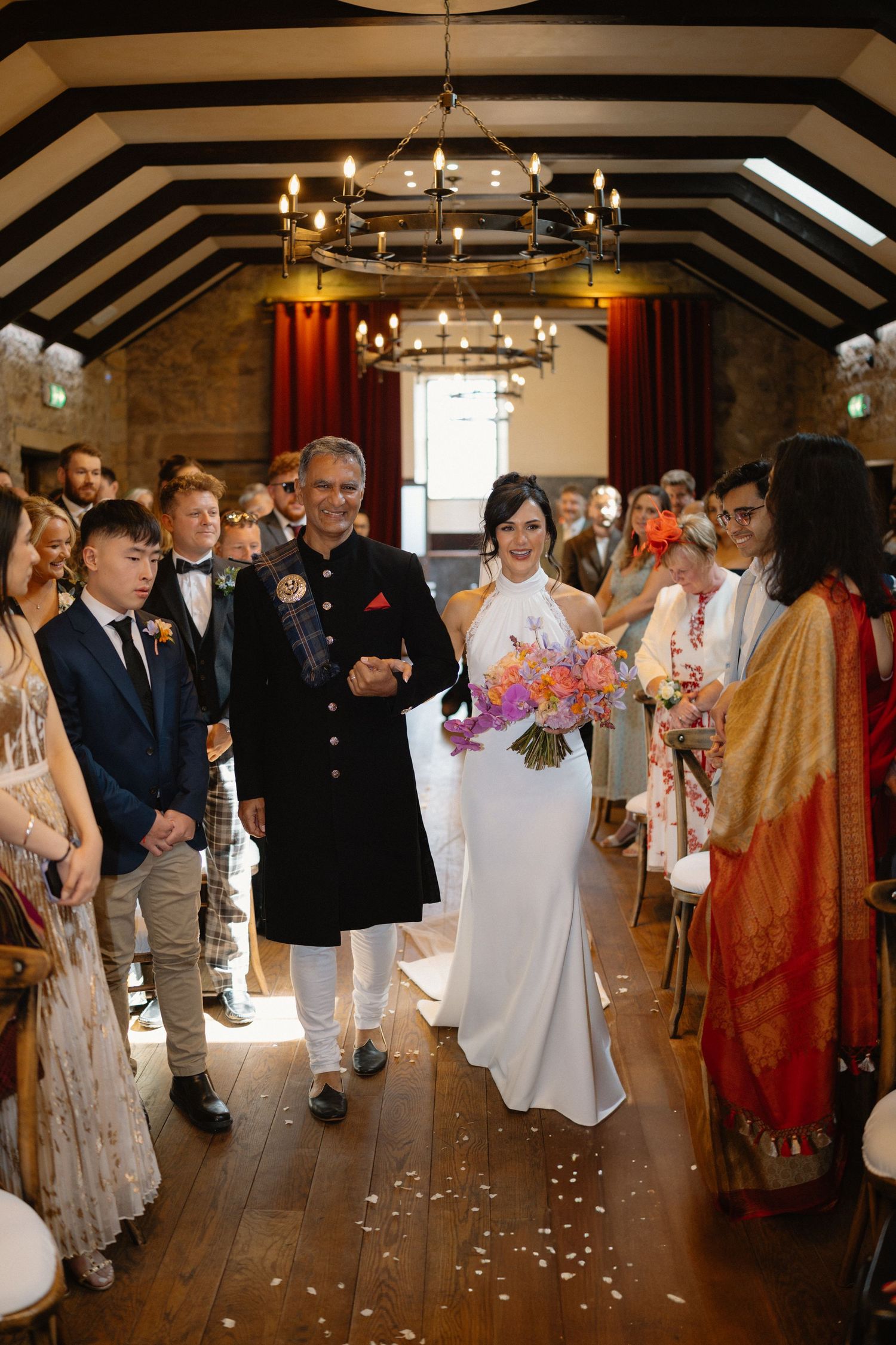 Wedding ceremony, bride walking down the isle with Dad, at Rosebery Steading, Temple, Gorebridge, Scotland.