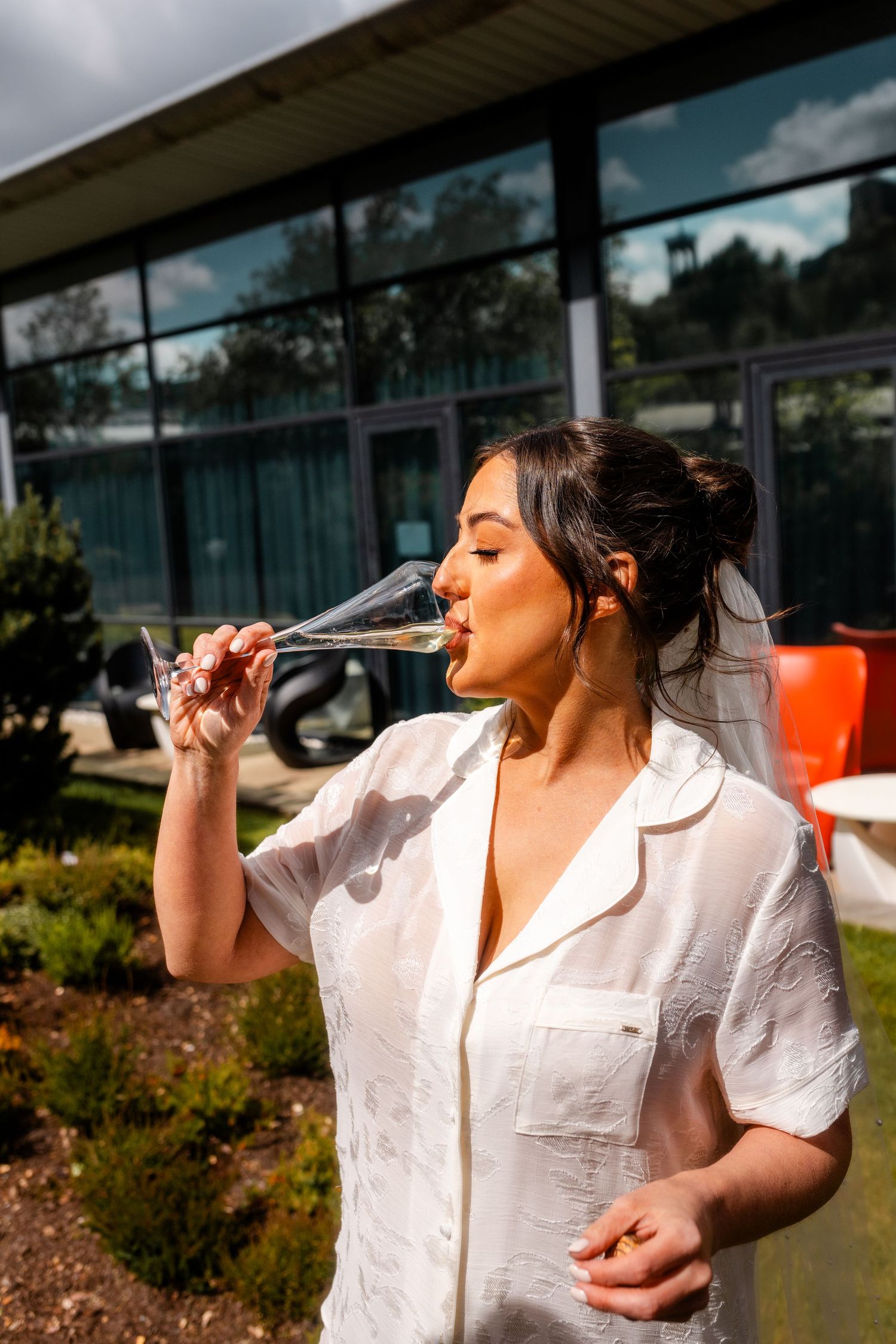 Bride drinking champagne the Glass House, Edinburgh, Scotland