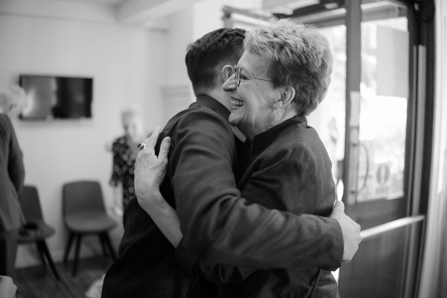 Groom hugging mum, black and white photos city photos on in Edinburgh Scotland