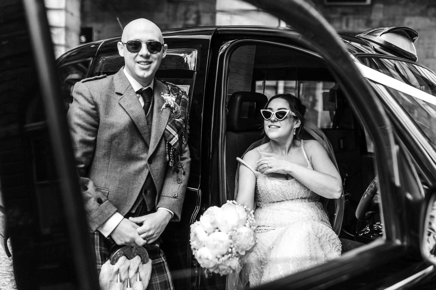 Bride and groom black and white in the taxi, City Chambers wedding in Edinburgh, Scotland,