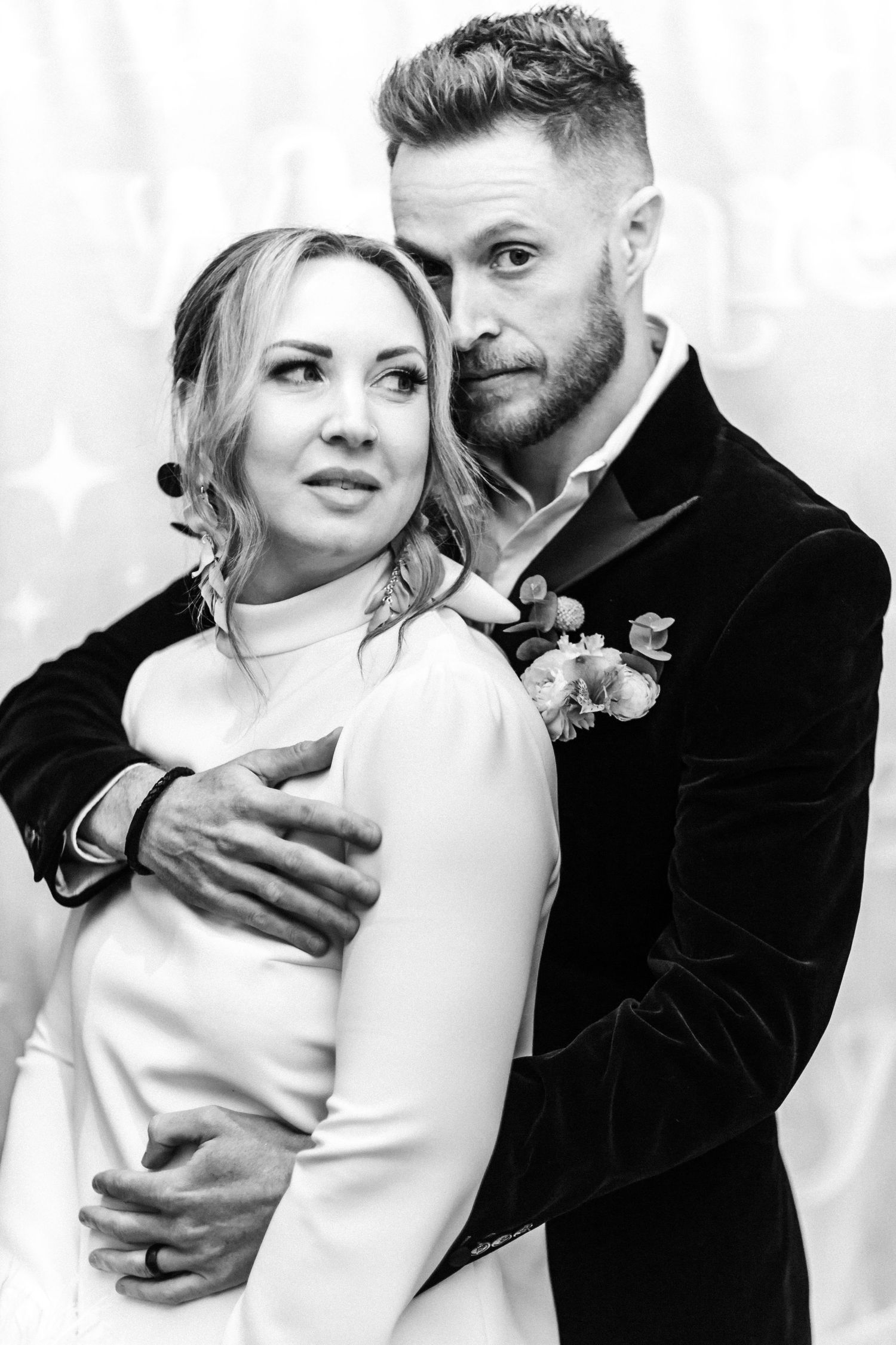 Black and white photo series showing intimate moments between a couple in wedding attire.