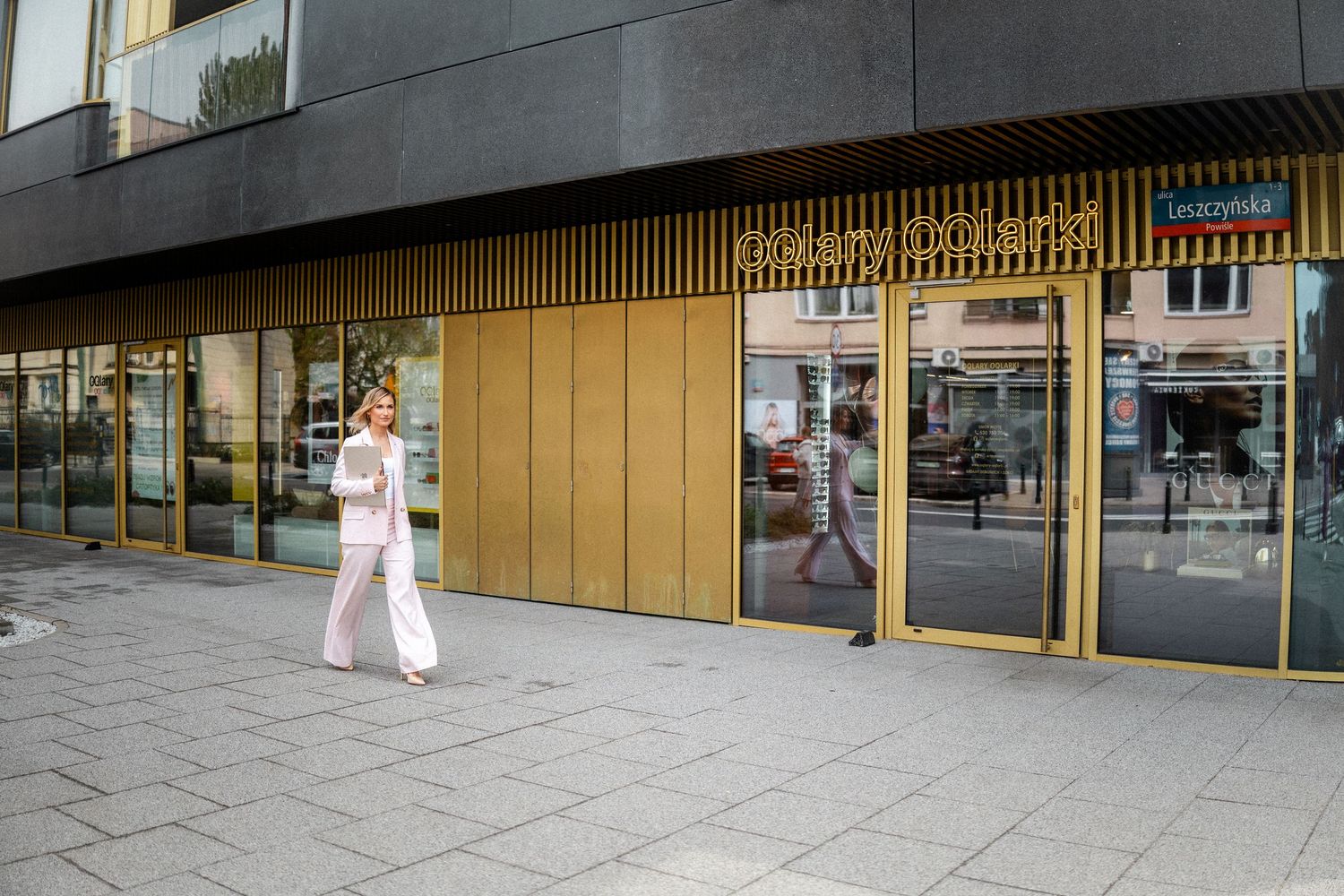 Modern commercial building exterior with sleek black and gold architectural details.