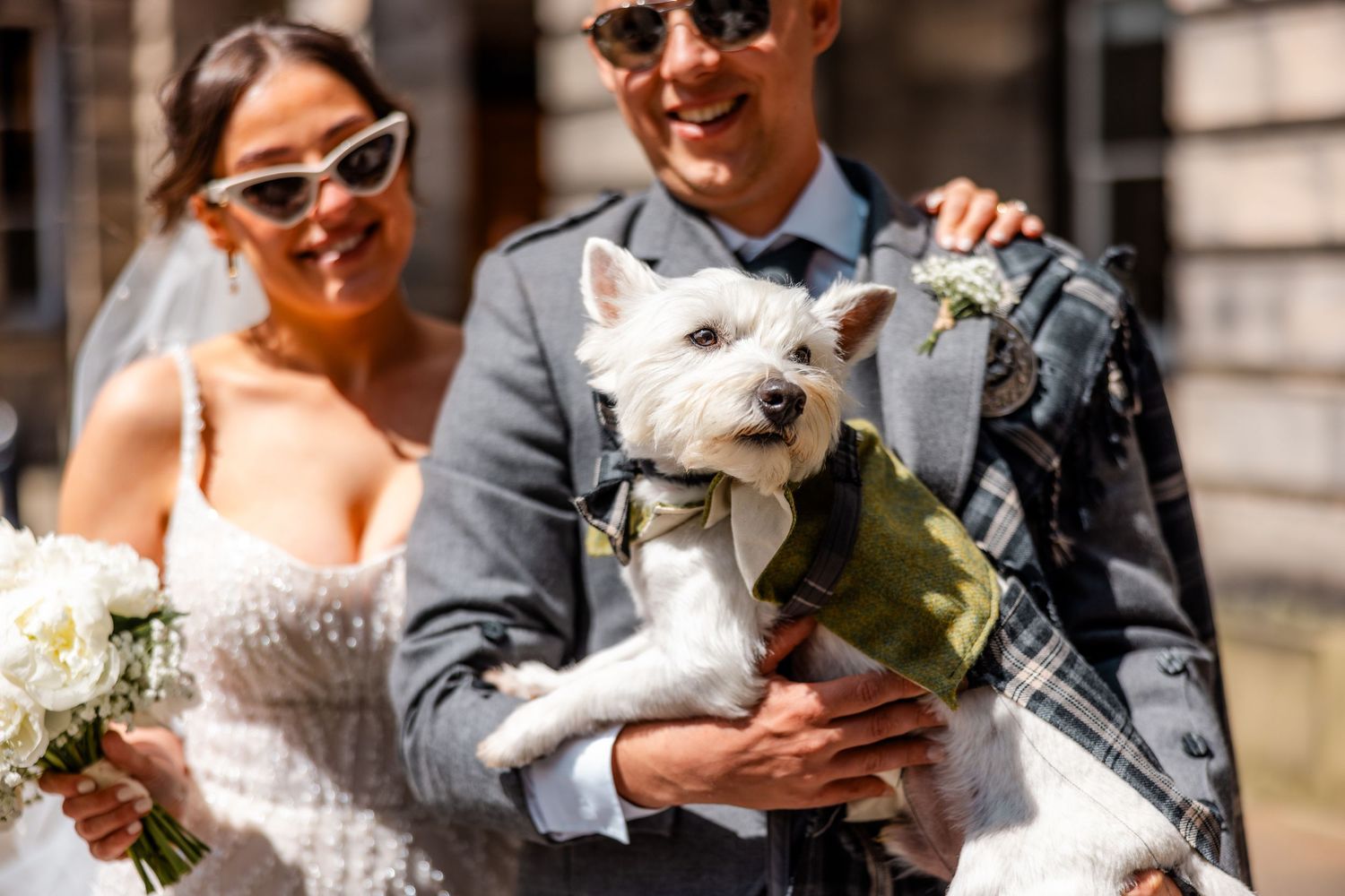 Bride and groom celebrating with their dog outside, City Chambers wedding in Edinburgh, Scotland,