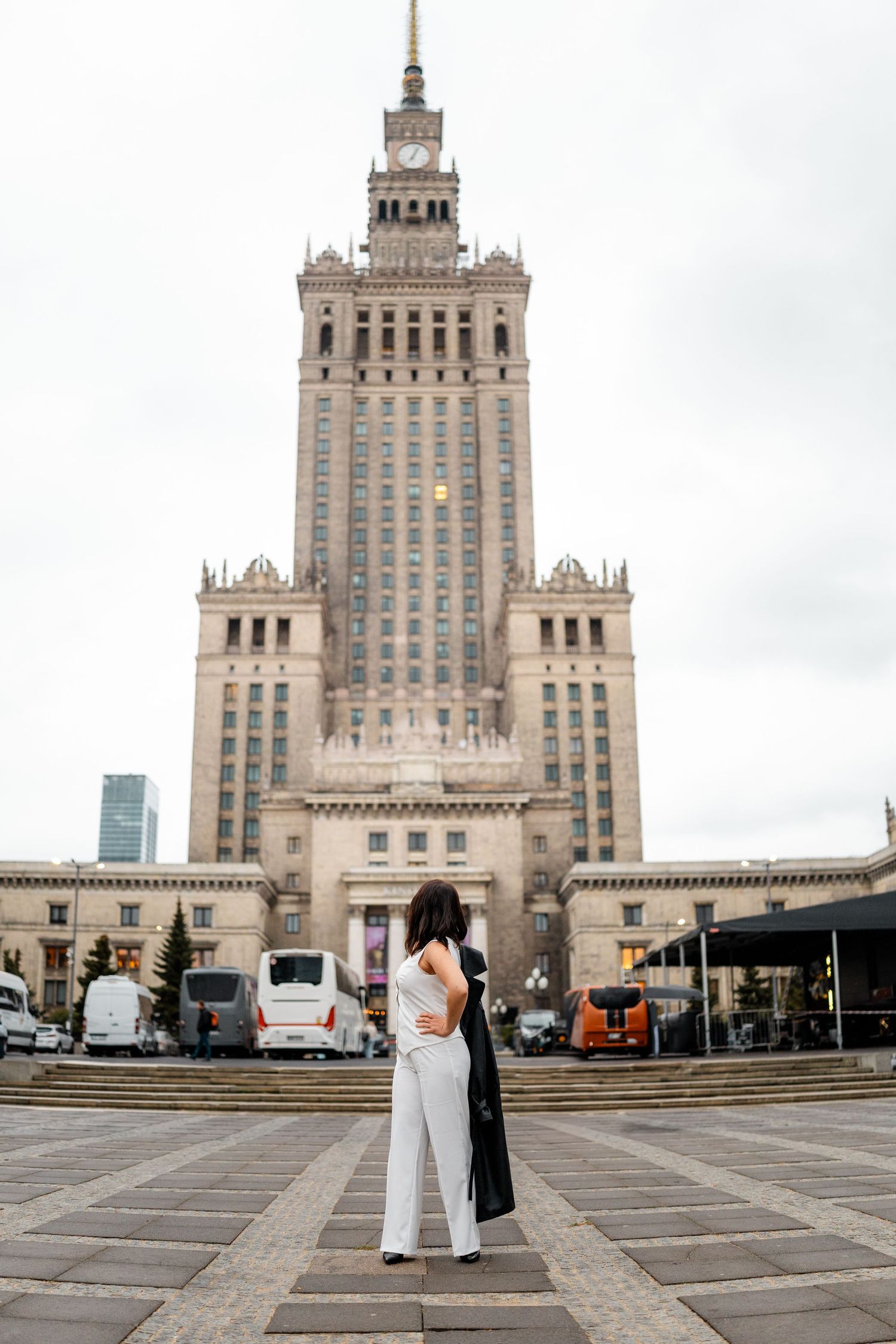 Wide angle shots of a couple dancing in front of Warsaw's iconic Palace of Culture and Science building.