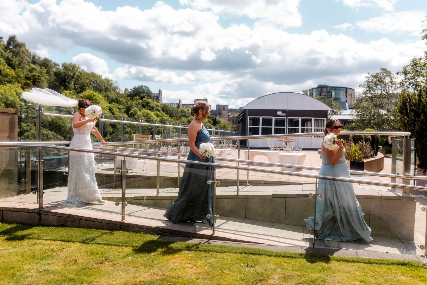 Celebrating women walking outside of the Glass House, Edinburgh, Scotland.
