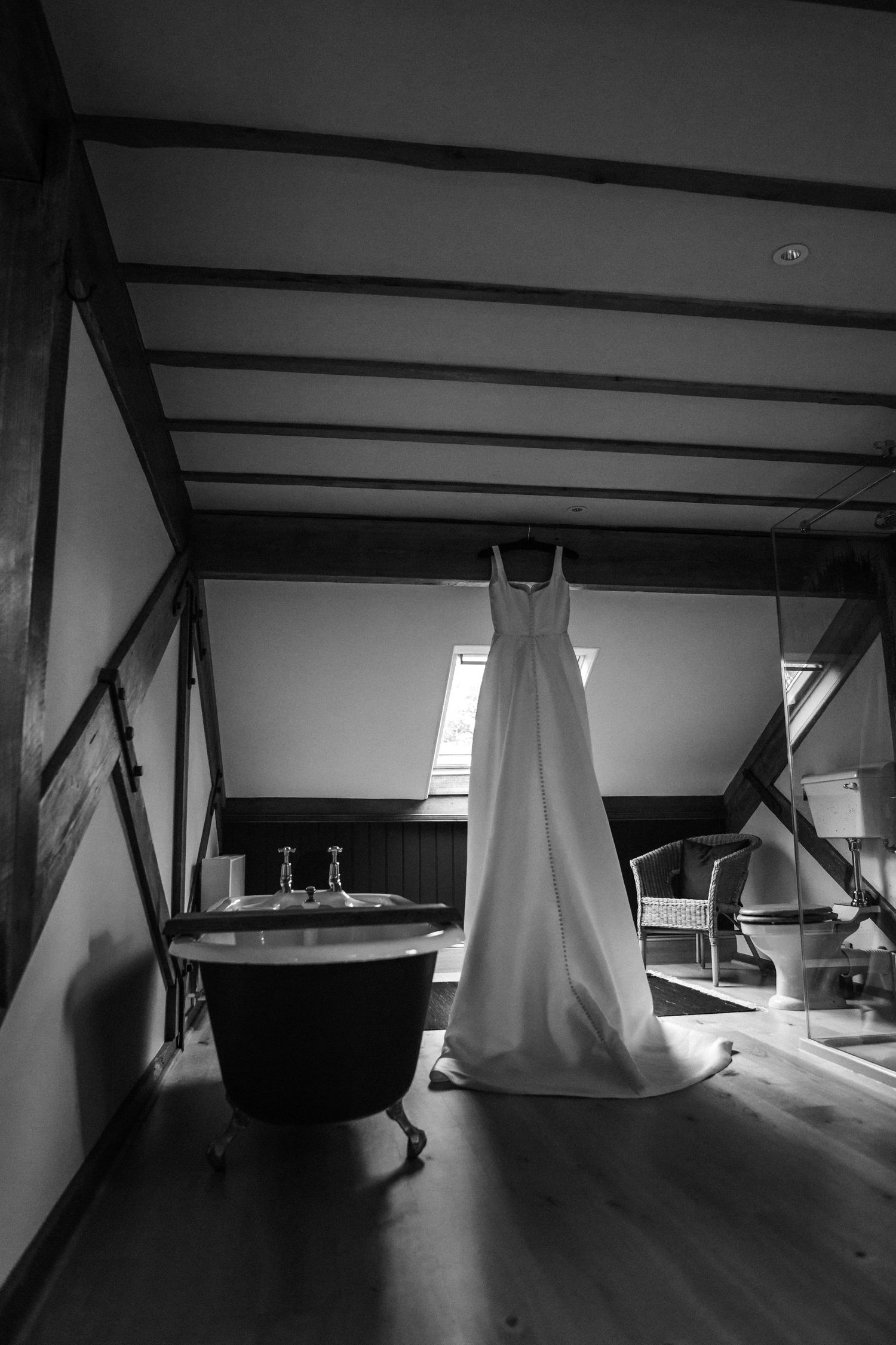 Black and white photo series showing a dark attic space with exposed beams and dramatic shadows.