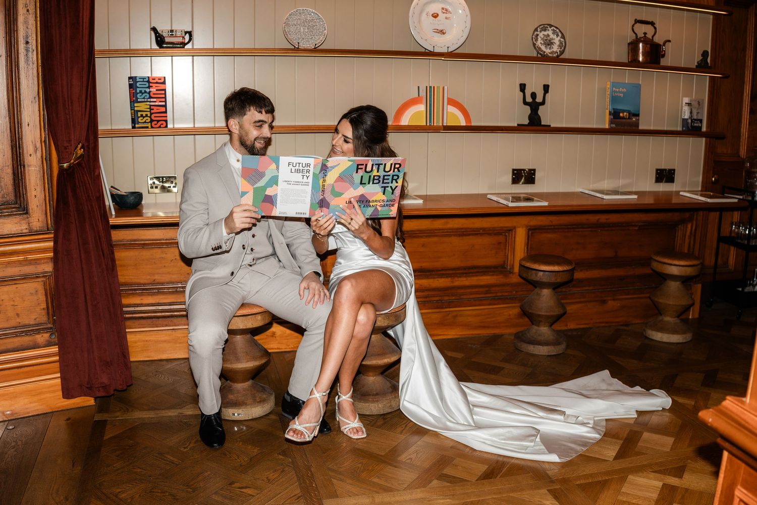 Wedding celebration in a cozy indoor venue with wooden floors and decorative plates on walls.