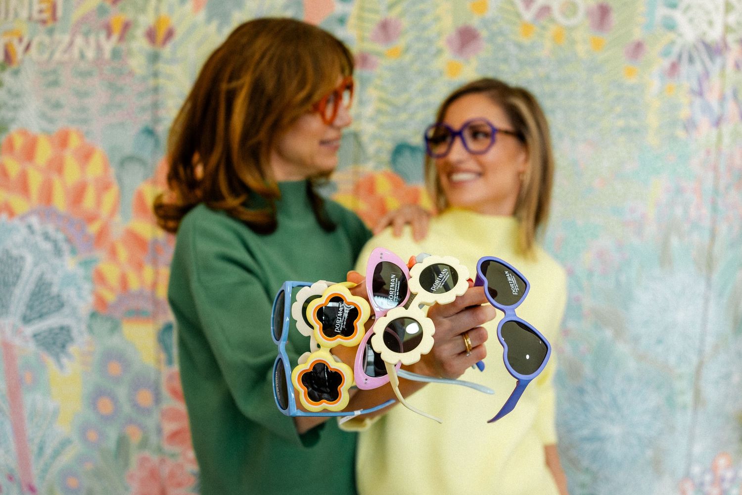 Colorful wall art serves as backdrop for playful interactions with props.