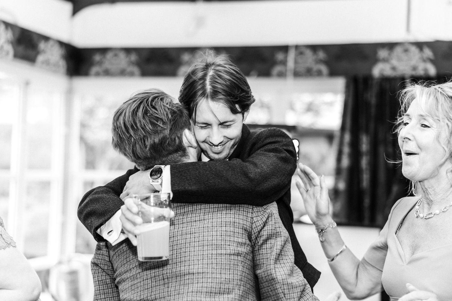 Guests hugging, dancing wedding, Glass House Edinburgh City Scotland,