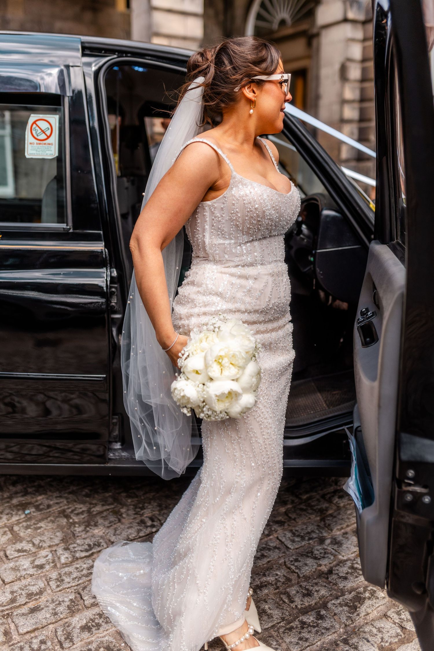 Lovely bride walking from taxi, City Chambers wedding in Edinburgh, Scotland,