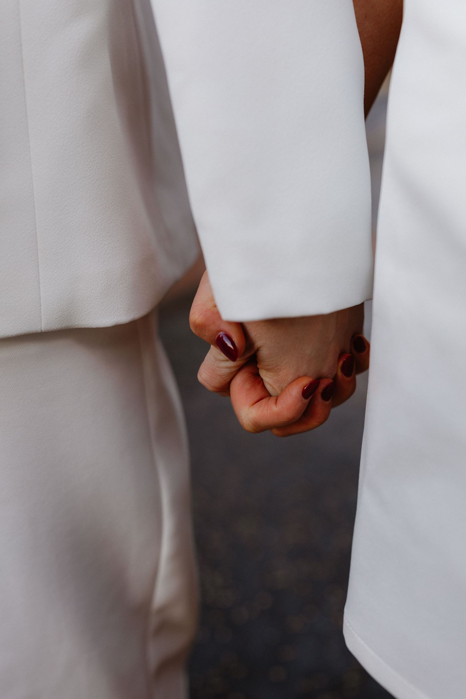Close-up detail shot of white wedding attire showing minimal clean lines.