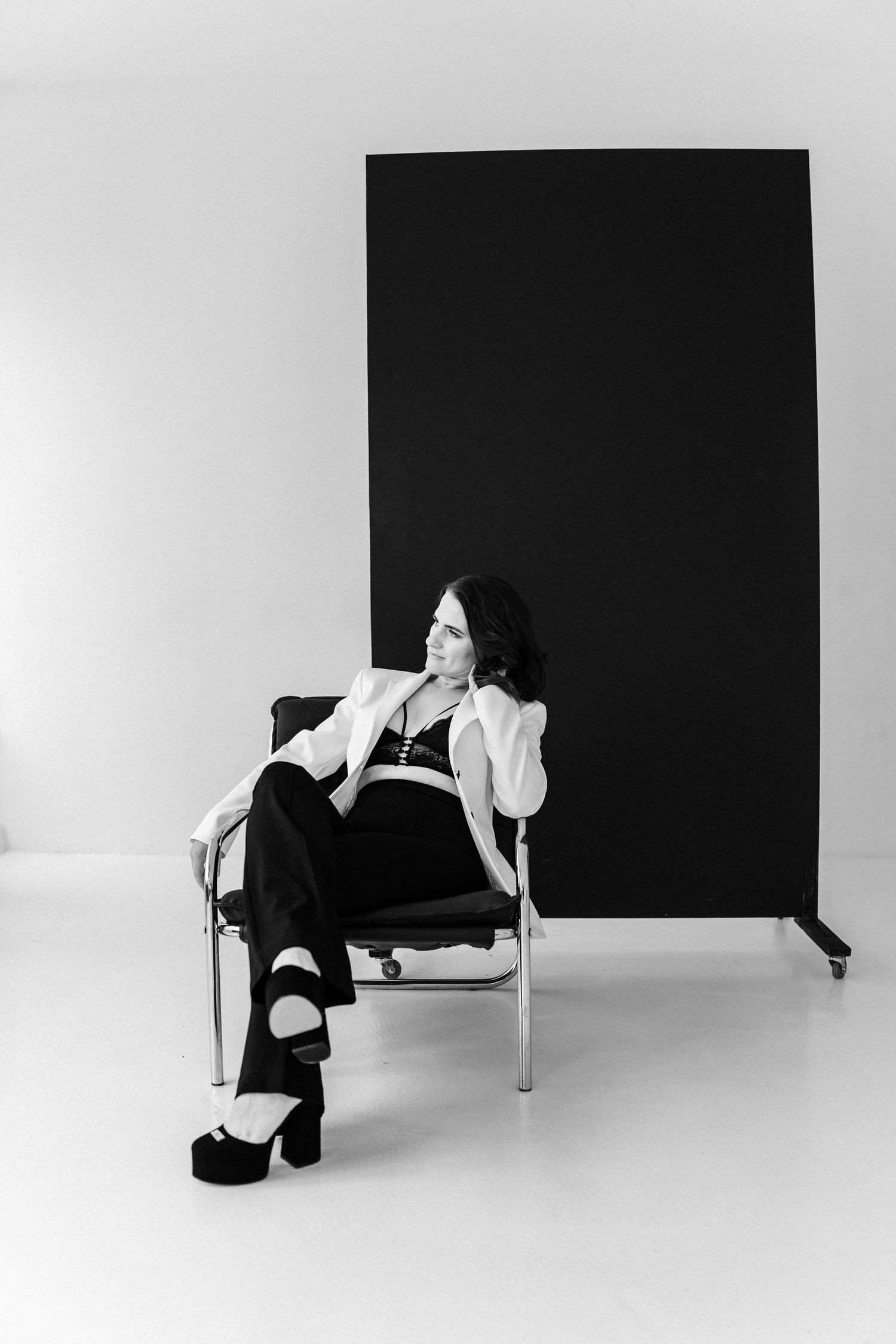Artistic black and white photo series showing dramatic poses on minimalist white and black backdrop.