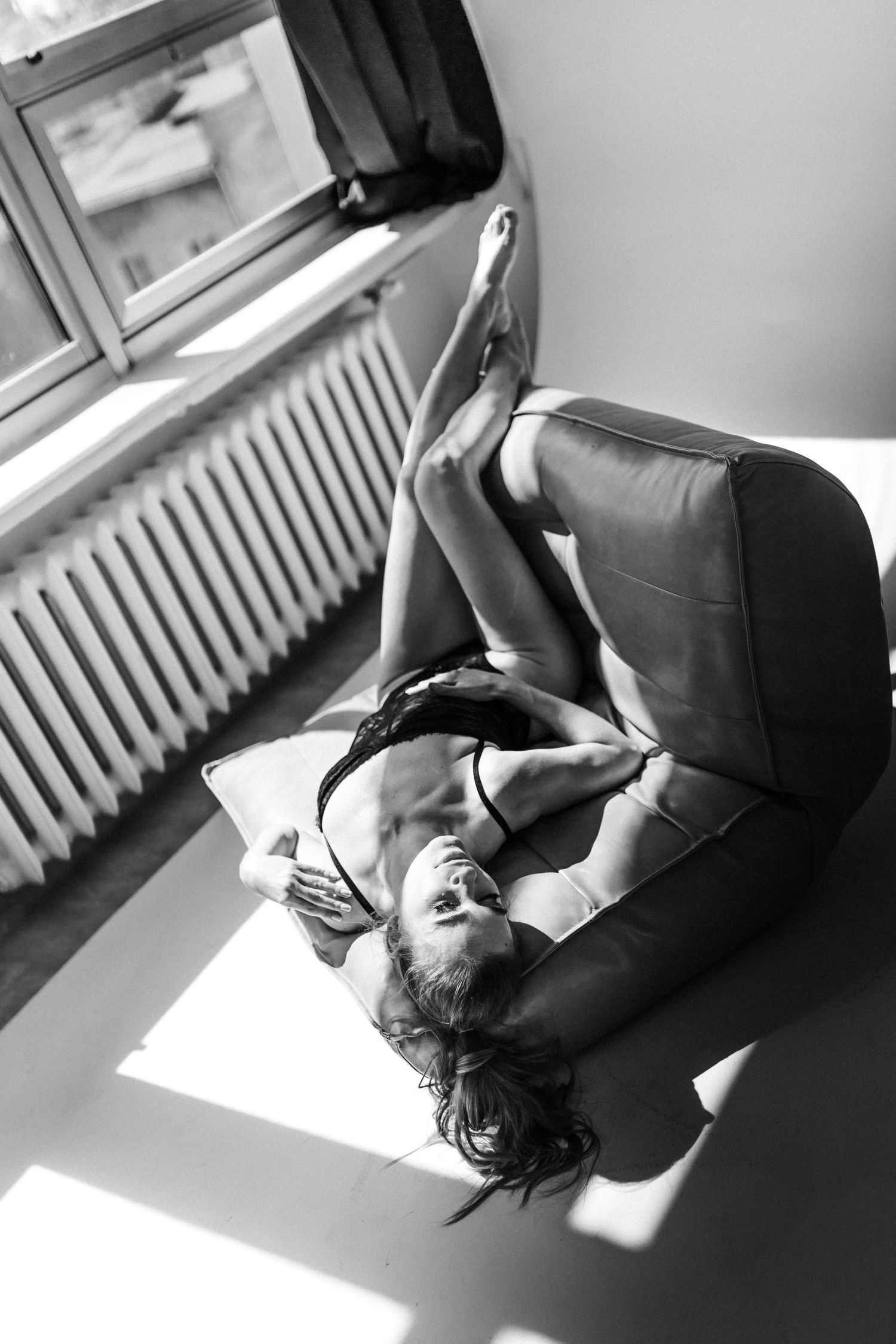 Black and white photograph showing dramatic poses near a window.