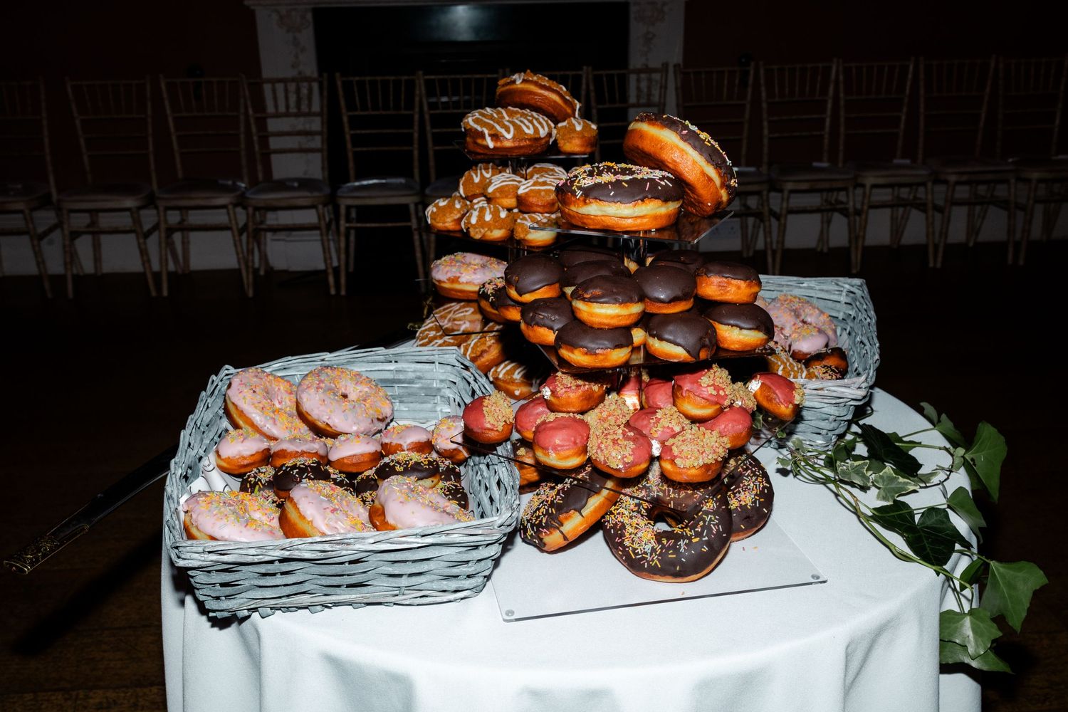 Buffet table filled with gourmet sliders and appetizers at a wedding reception.