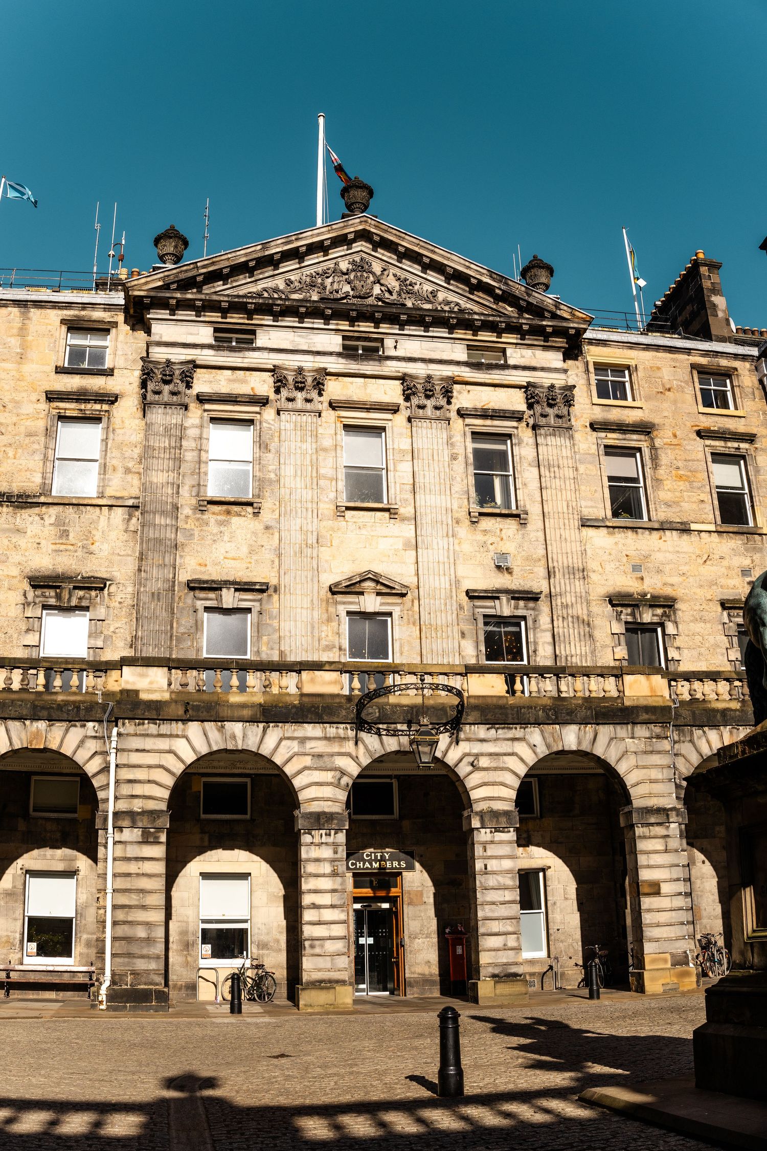 Exterior view of a classical stone building with Georgian architecture and arched windows.