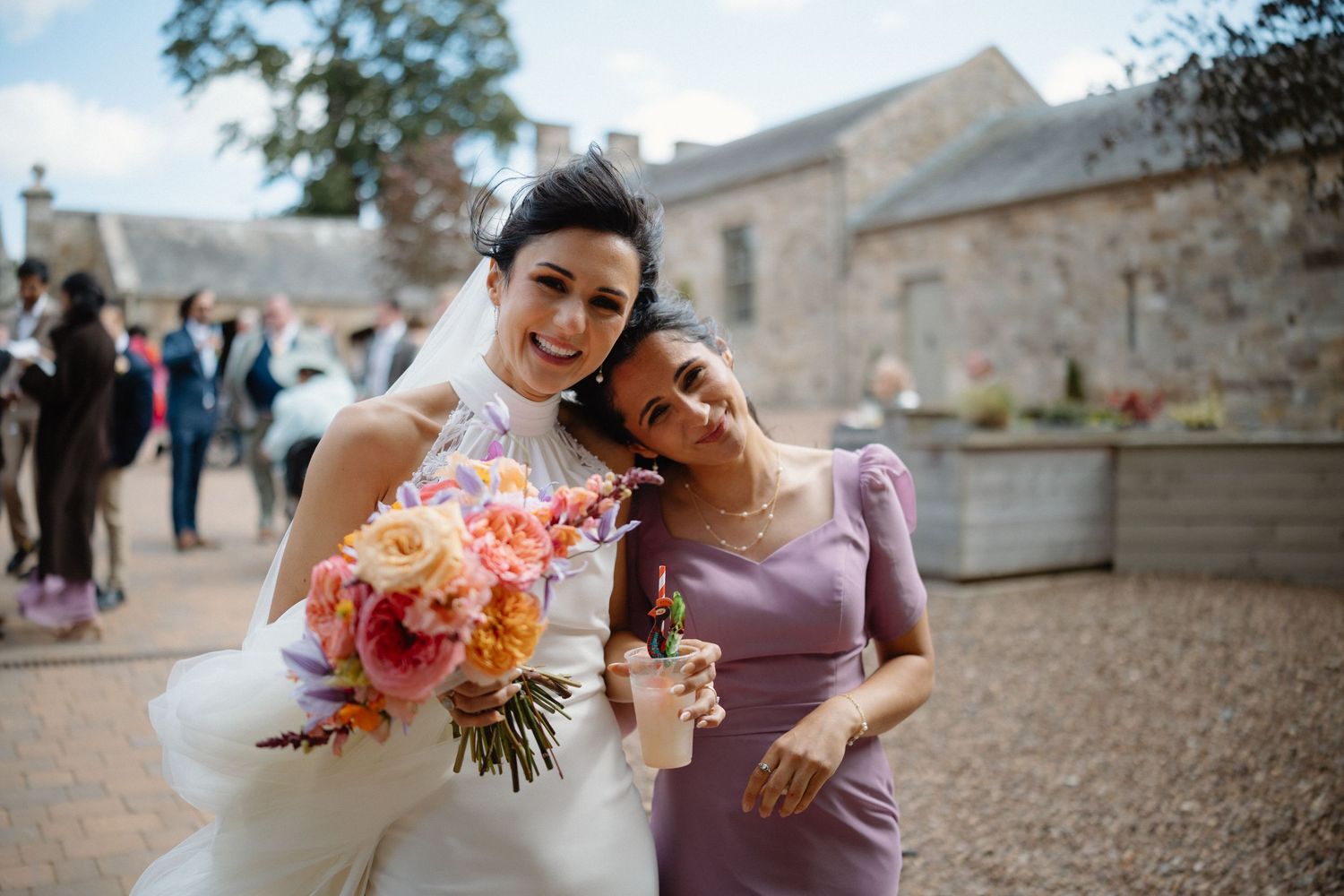 Wedding bride with sister courtyard at Rosebery Steading, Temple, Gorebridge, Scotland.