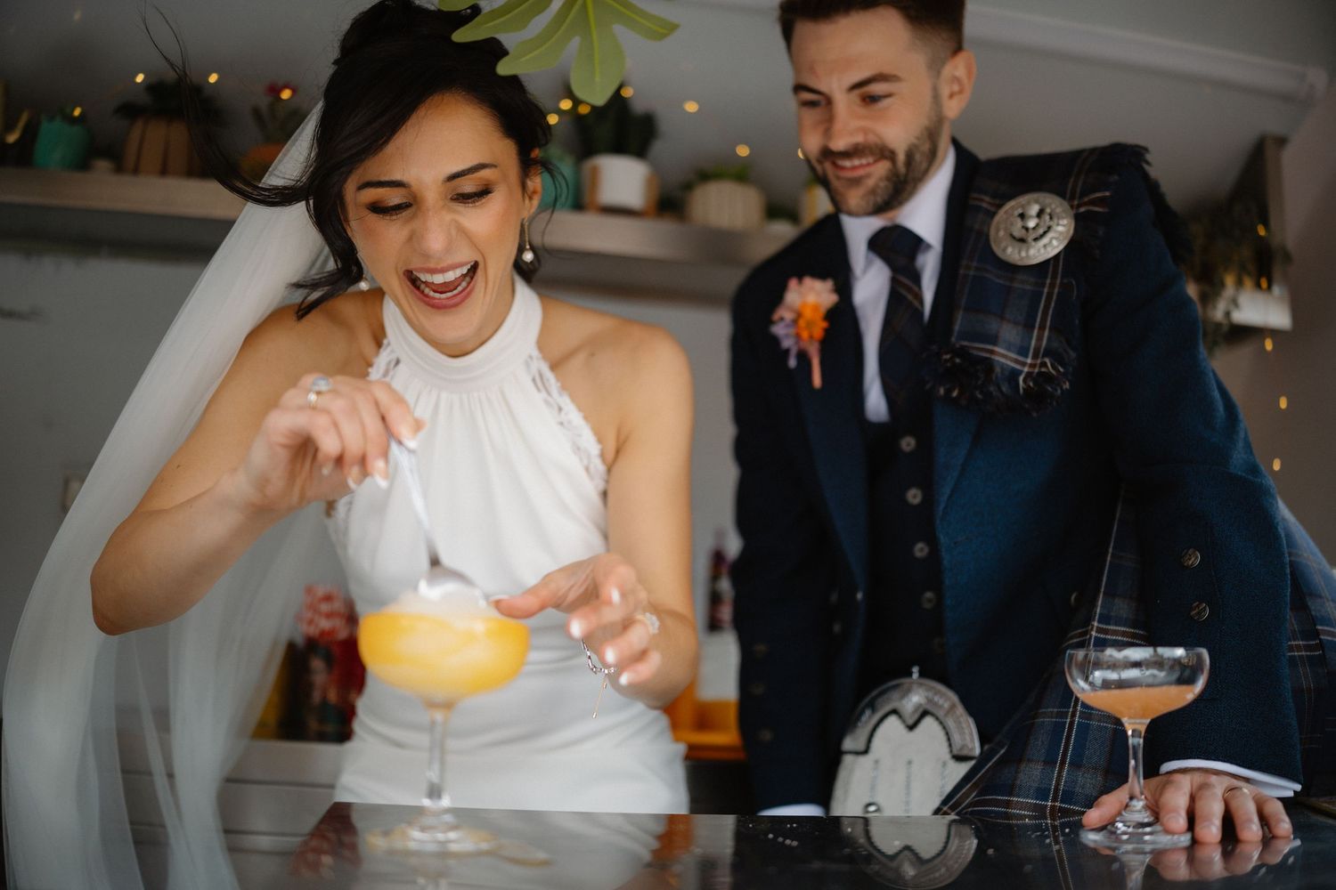 Wedding guests enjoying cocktails and drinks at an indoor reception.