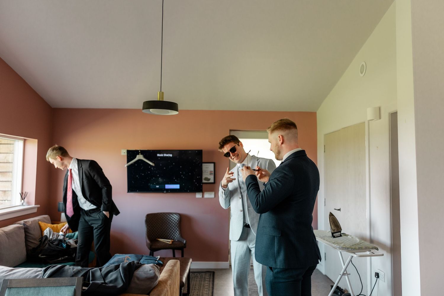 Interior shots of wedding preparation activities in a bright modern room.