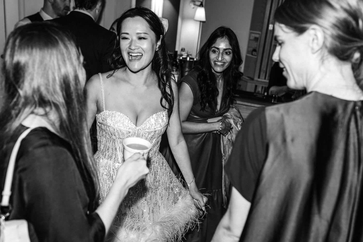 Wedding guests mingling and dancing at an evening reception.