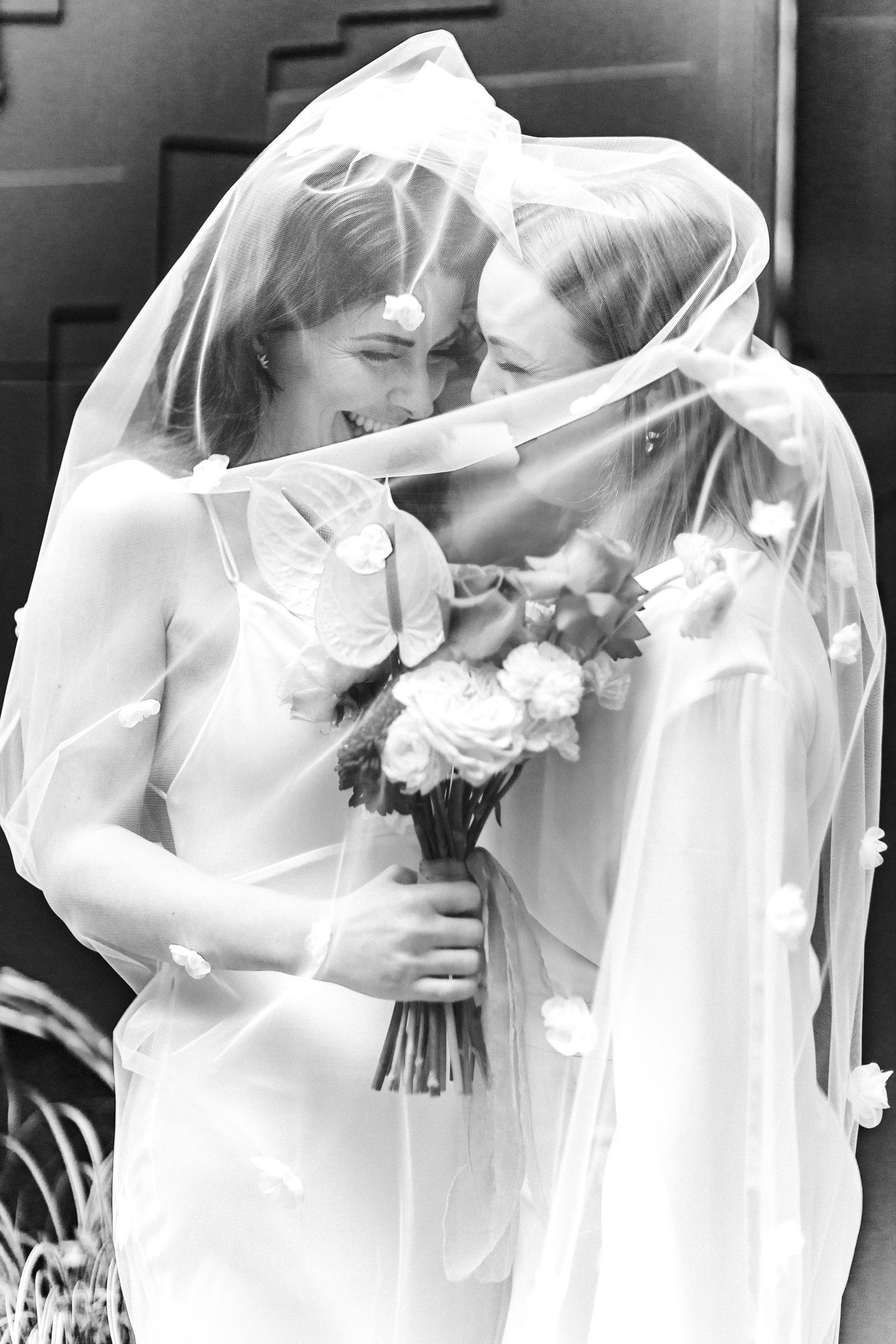 A series of intimate black and white wedding moments showing tender embraces.