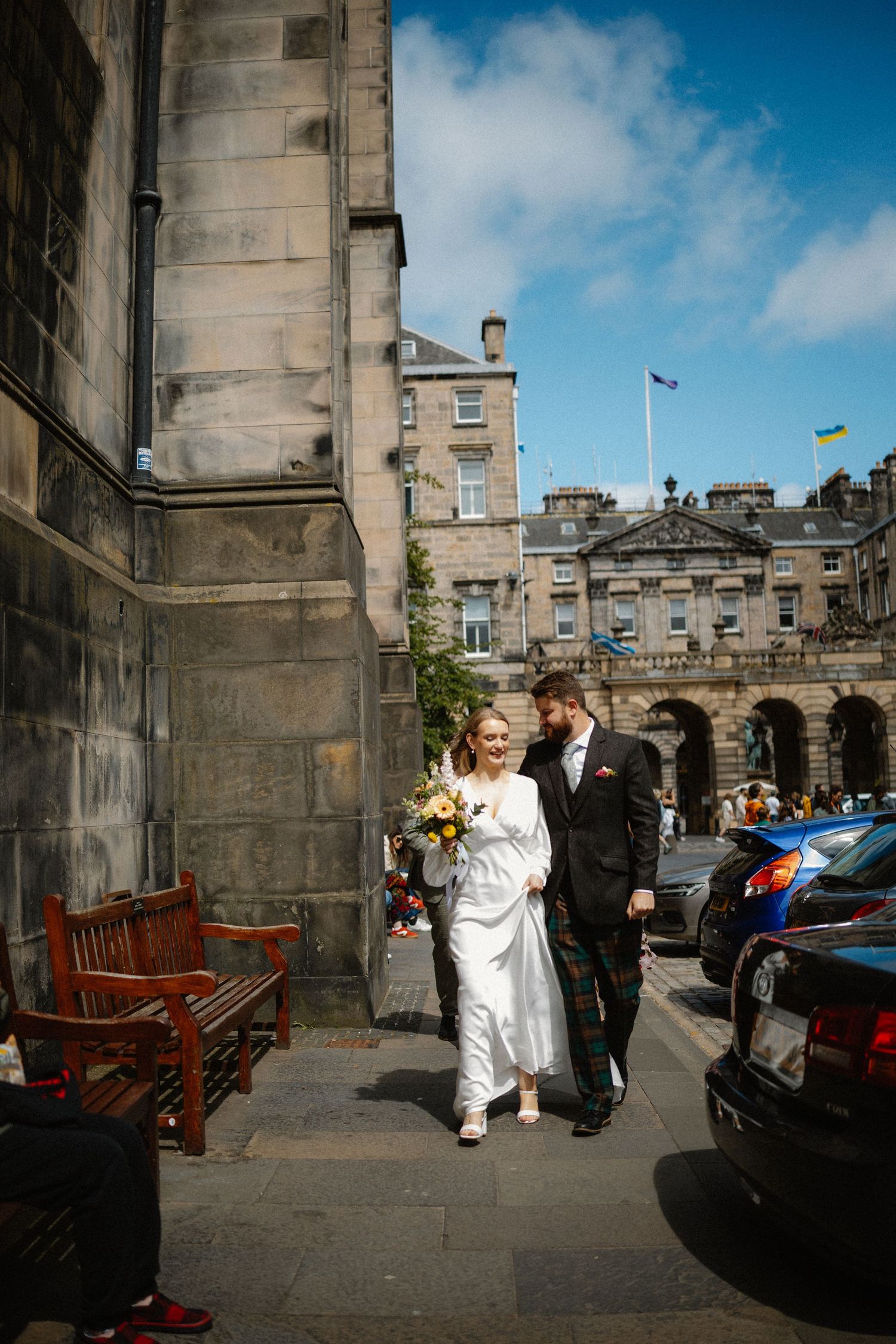 Bride and groom walking around the city  in Edinburgh Scotland