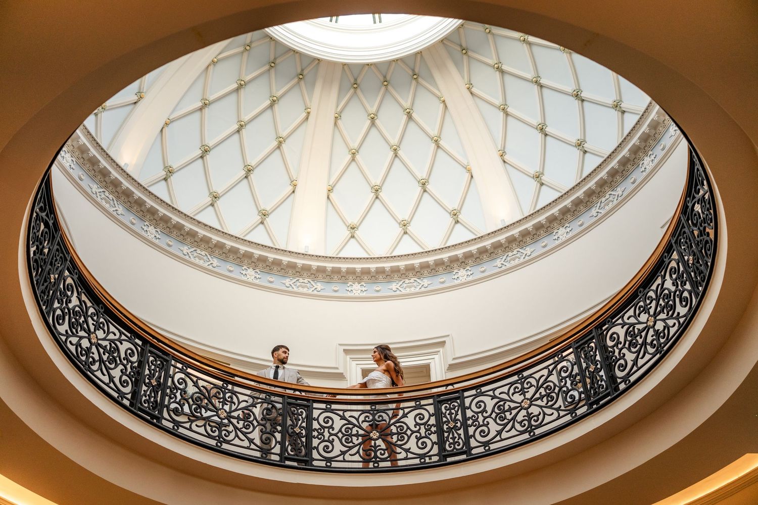 Elegant domed ceiling with ornate architectural details and lighting fixtures.