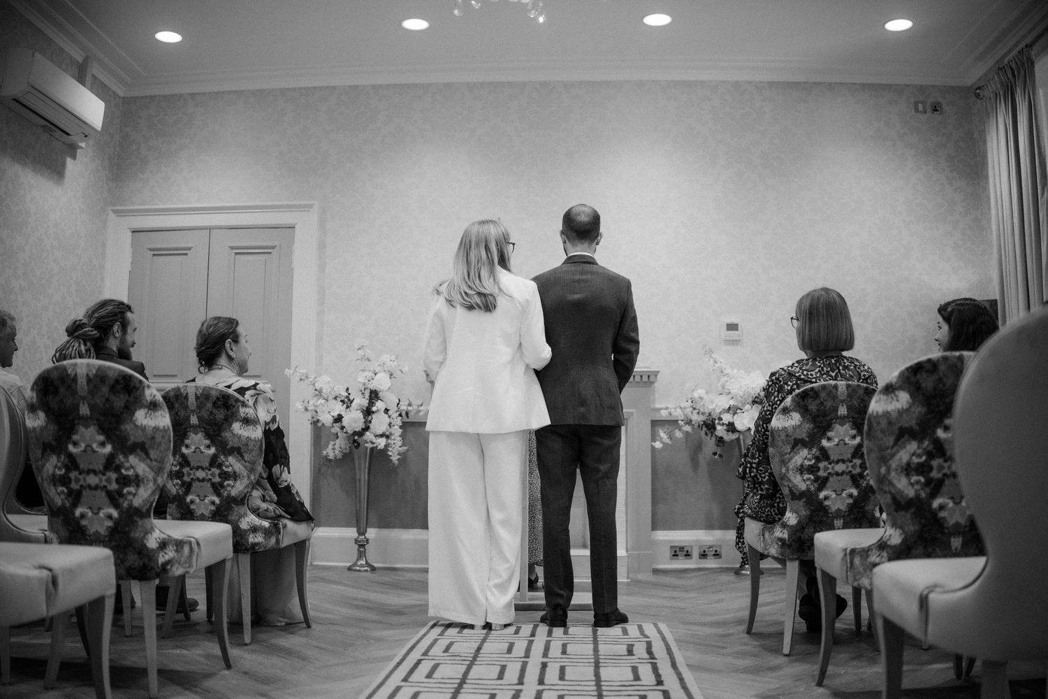 Black and white wedding ceremony moments in an elegant indoor venue.