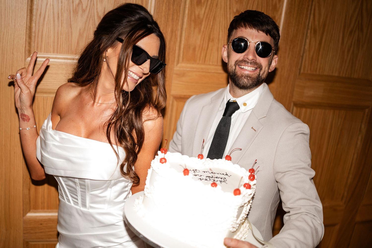 A celebratory moment with a wedding cake in an elegant indoor setting.