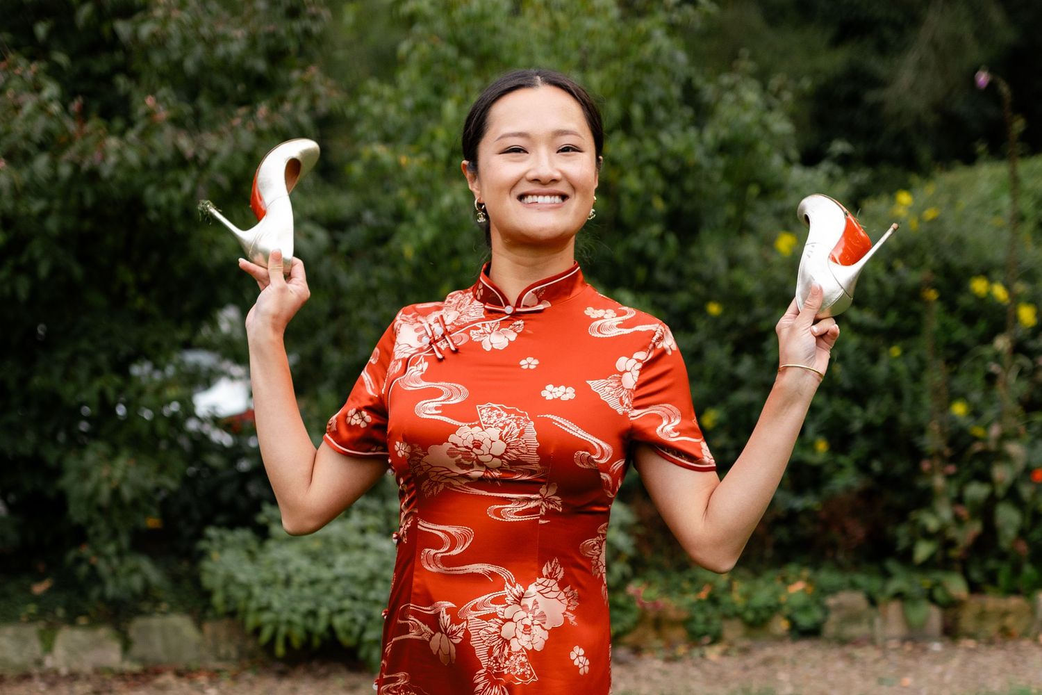 Joyful celebration poses outdoors in traditional Chinese dress.