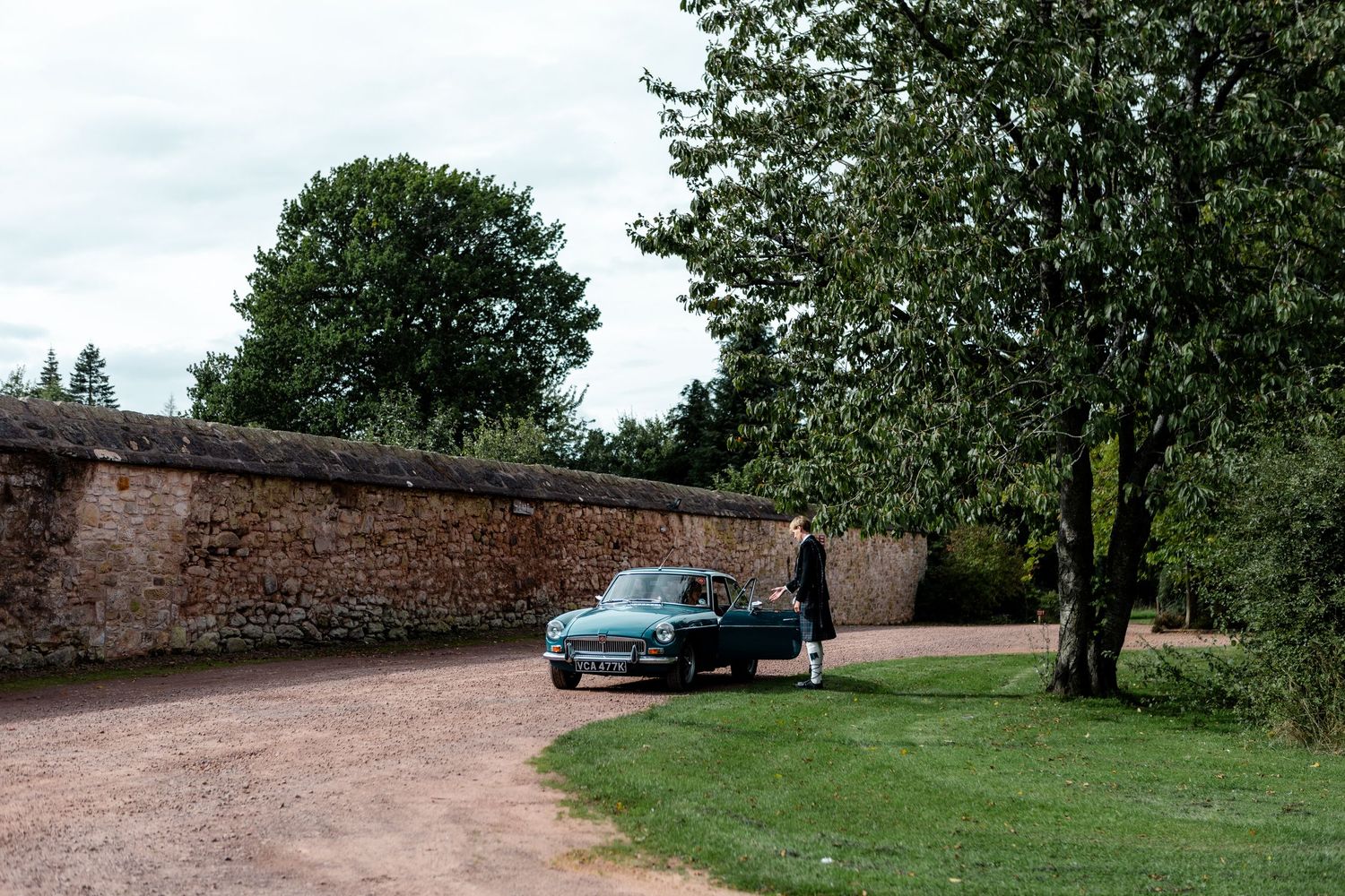 A series of panoramic landscape shots showing a dirt path winding through green fields with trees and stone walls.