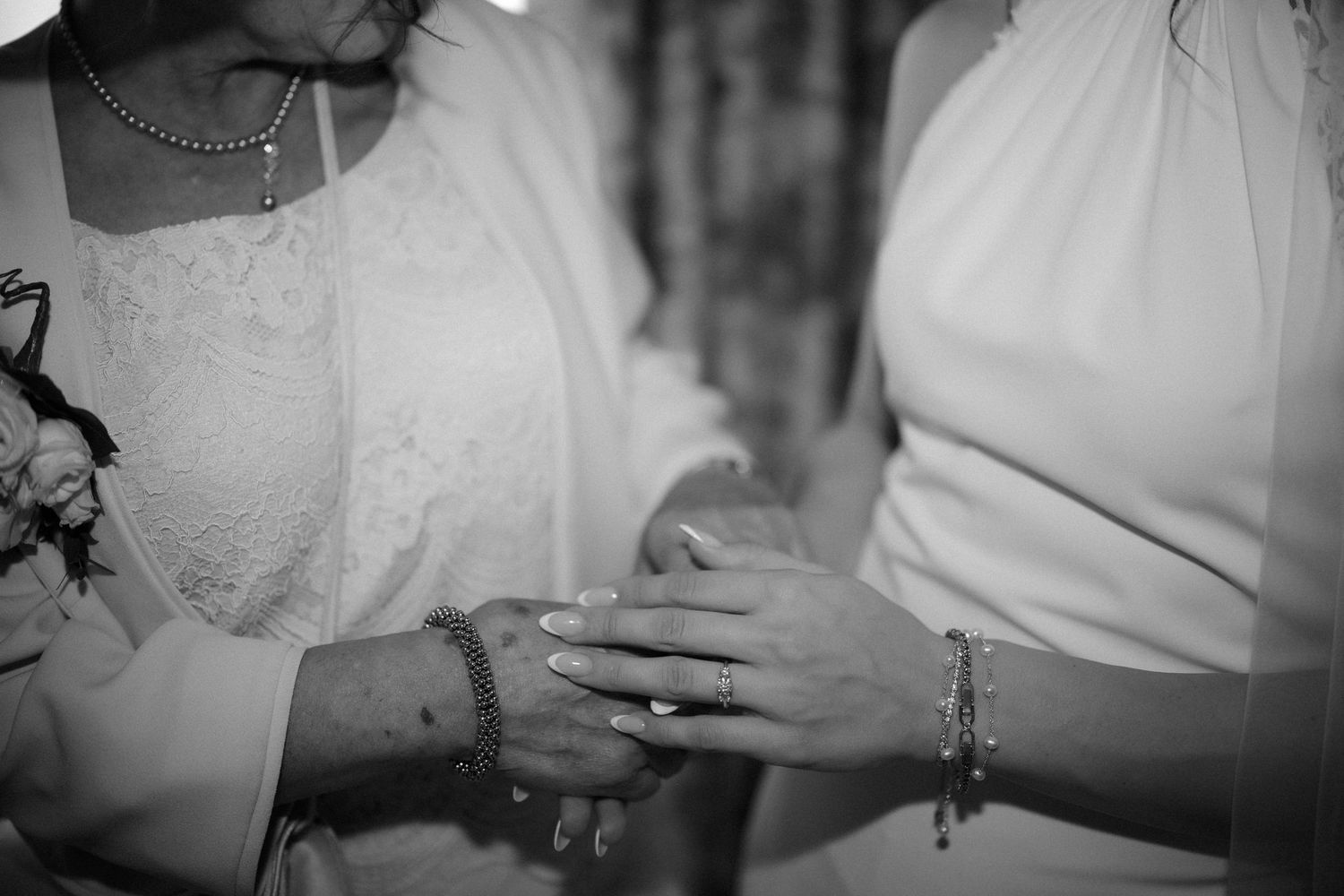 Close-up black and white details of wedding dress and accessories.