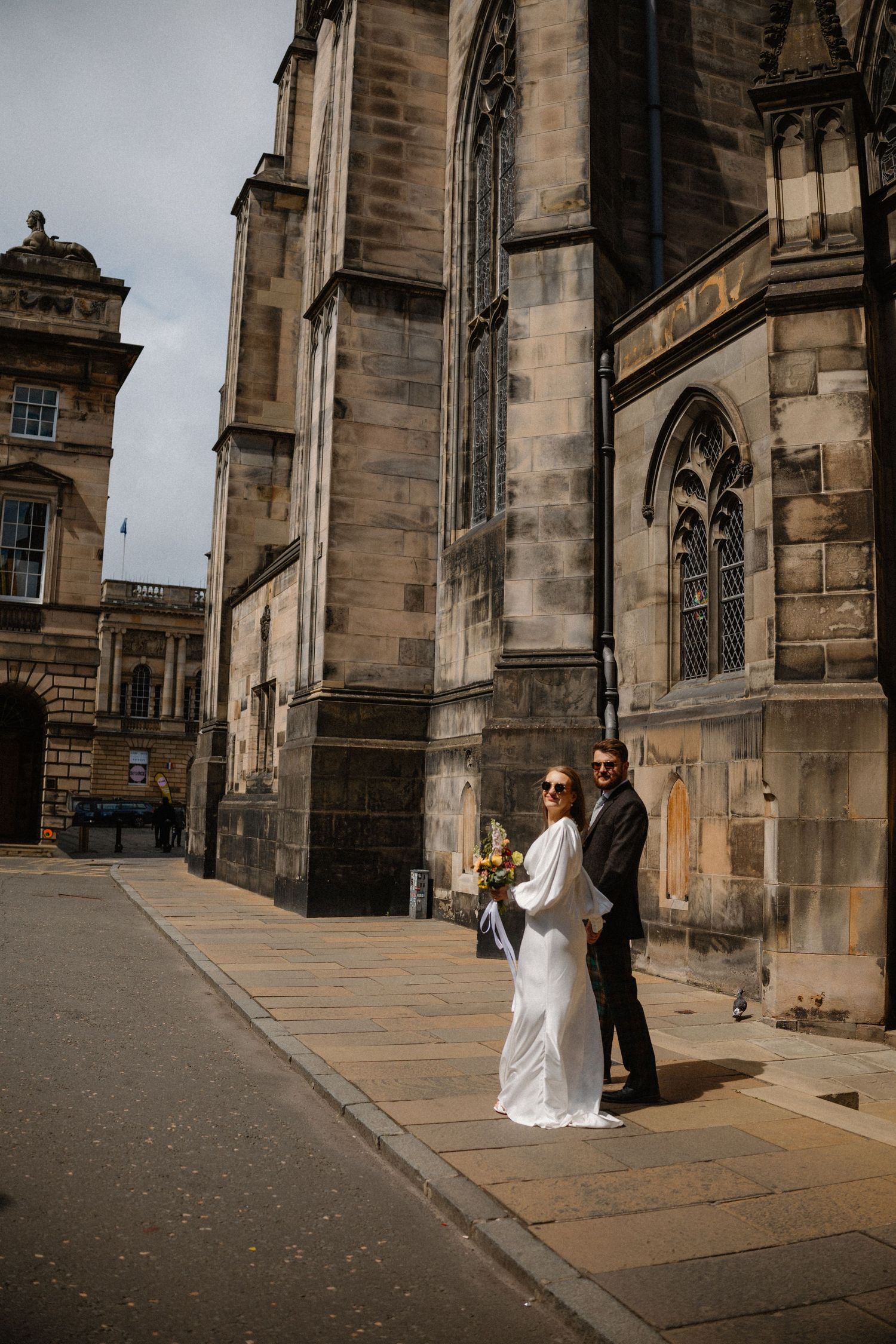 Bride and groom walking around the city  in Edinburgh Scotland