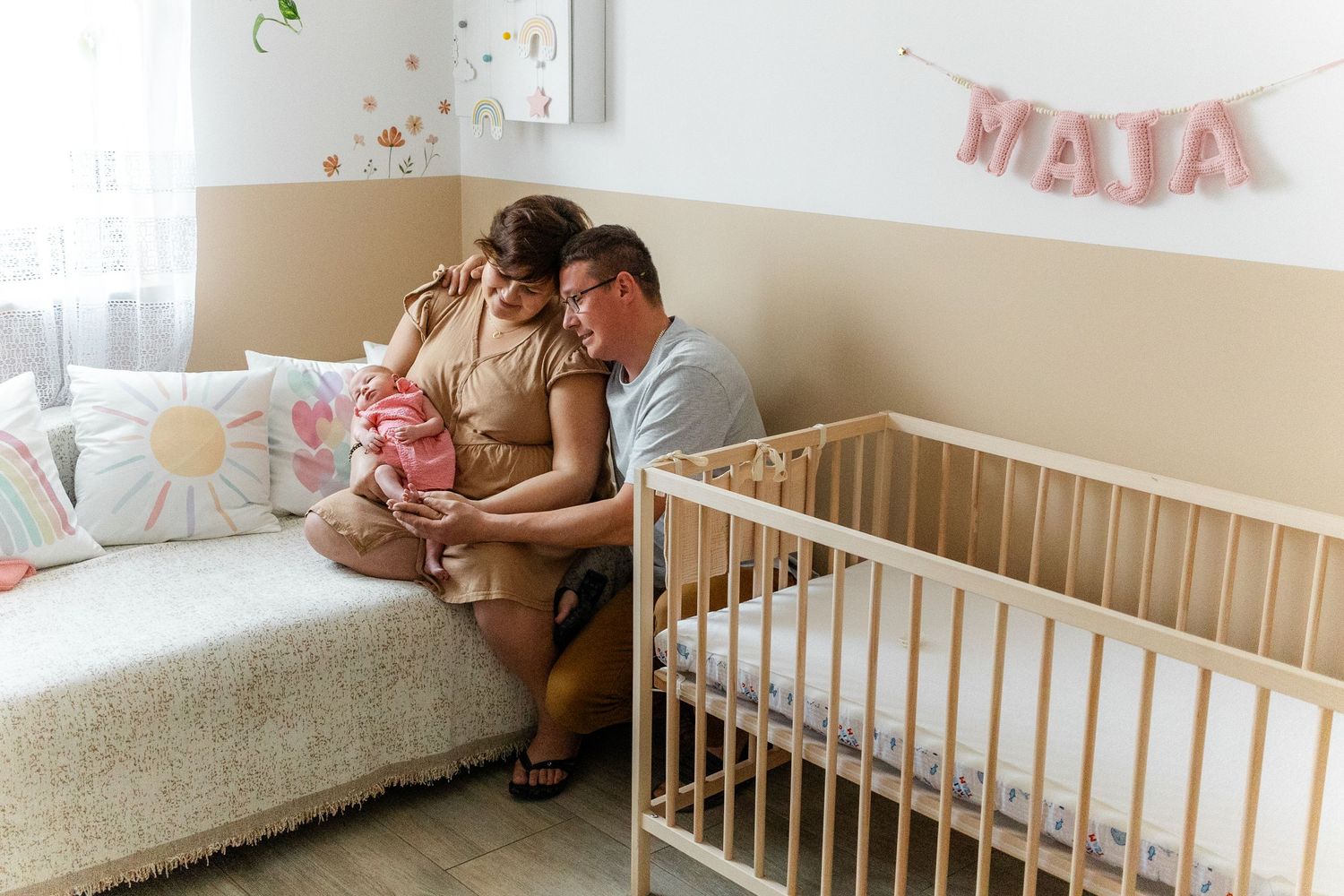 Nursery room interior with white crib and decorative wall details.
