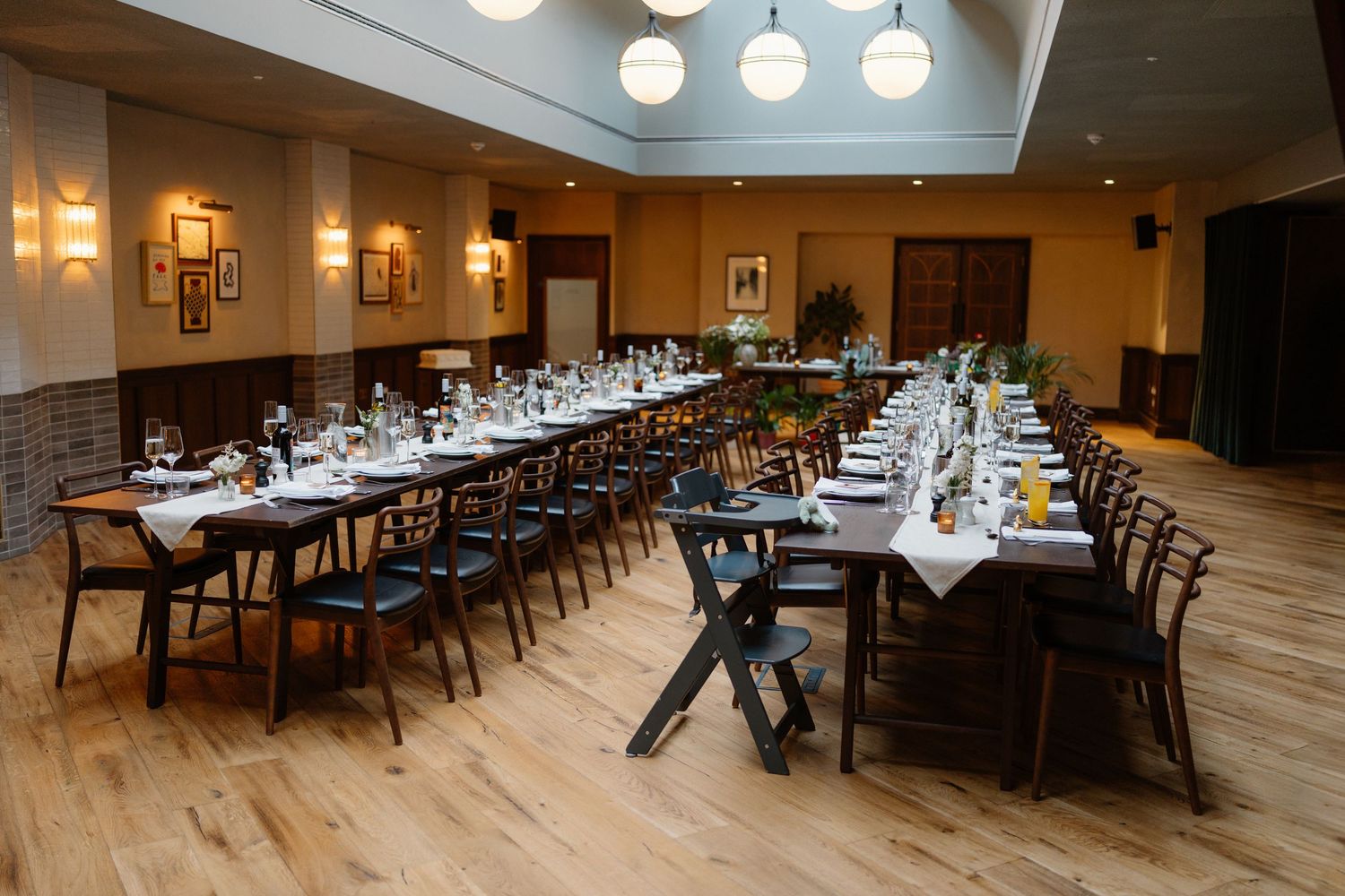 Elegant wedding reception venue with long banquet tables set with white linens and floral centerpieces.