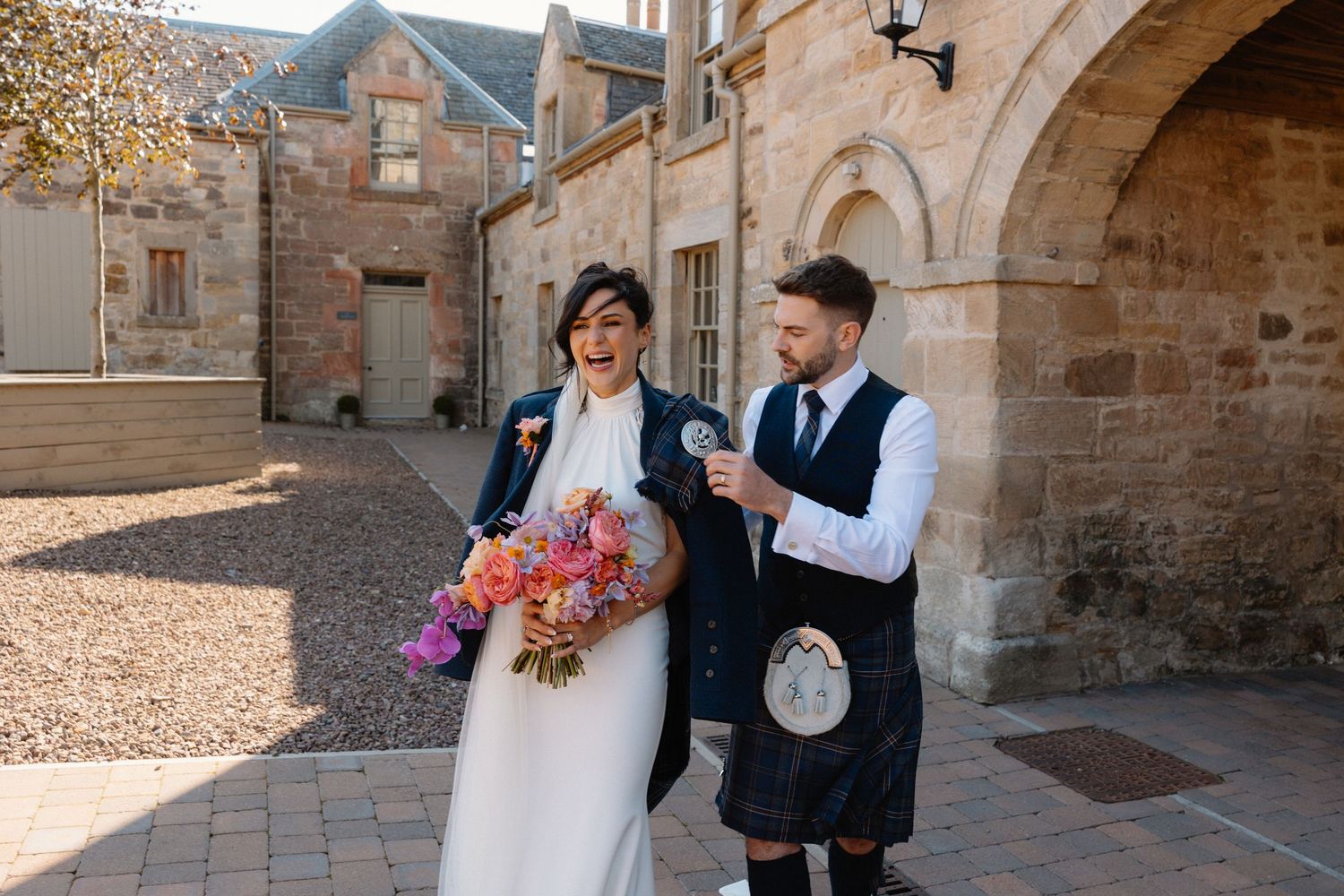 Wedding courtyard bride and groom at Rosebery Steading, Temple, Gorebridge, Scotland.