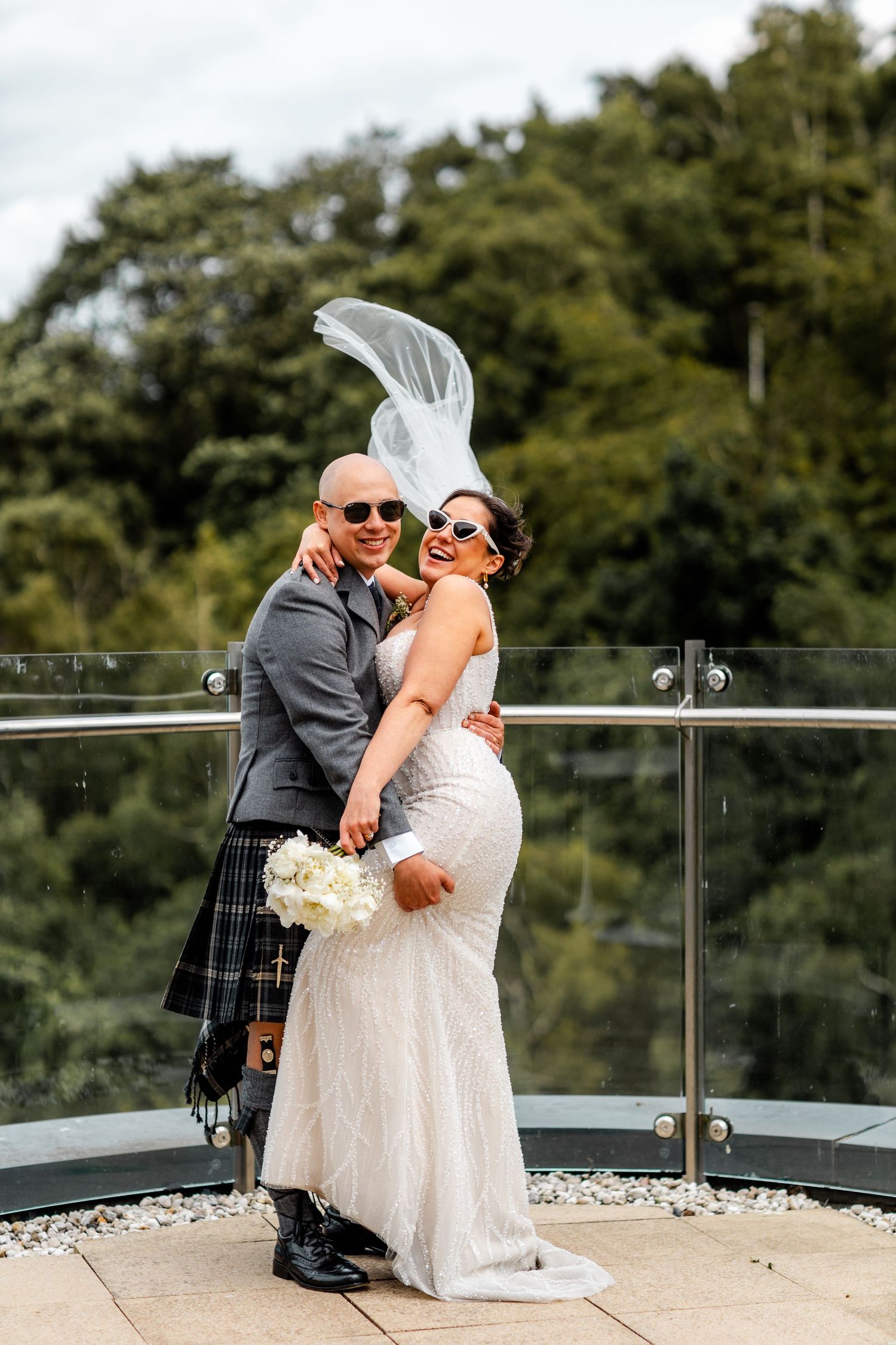 Bride and groom, wind tossing a vail, wedding Glass House Edinburgh, Scotland,