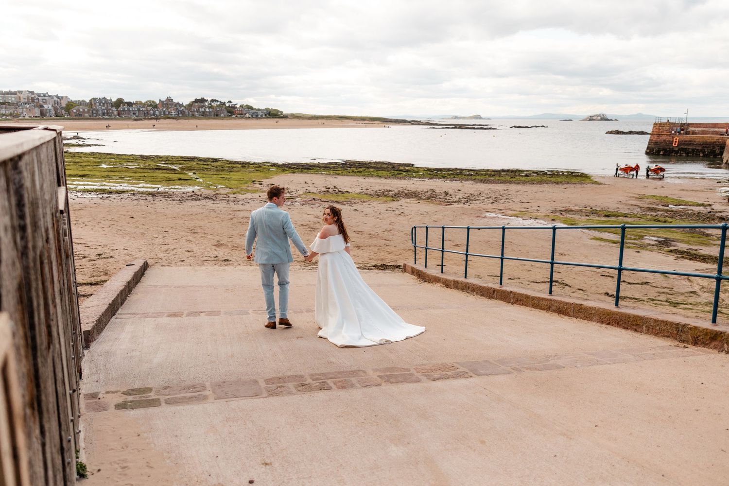 A series of panoramic beach landscape photos showing coastal paths and wooden railings along the shoreline.