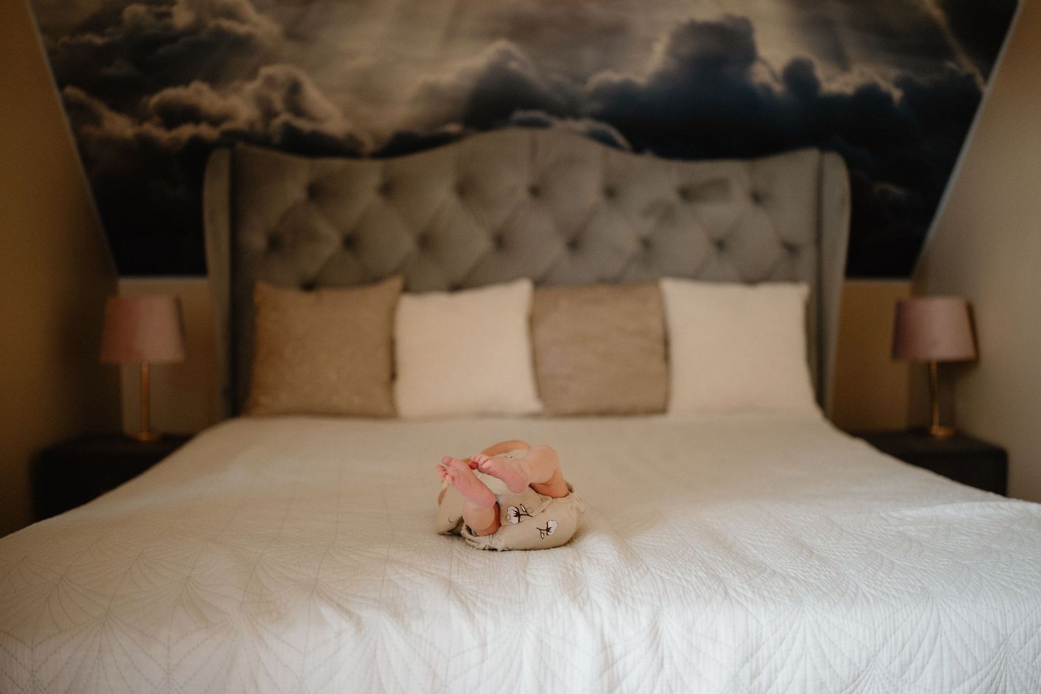 Modern bedroom interior with tufted headboard and soft lighting.