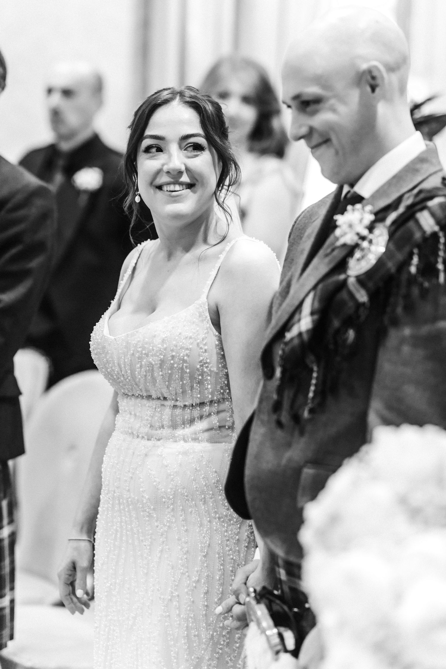 Bride looking with a smile at the groom, black and white. City Chambers wedding in Edinburgh, Scotland,