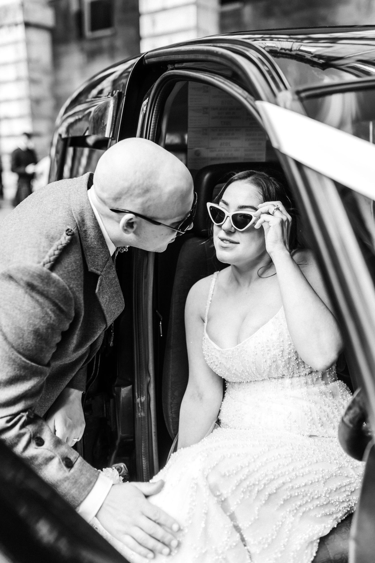 Bride and groom in taxi, City Chambers wedding in Edinburgh, Scotland,