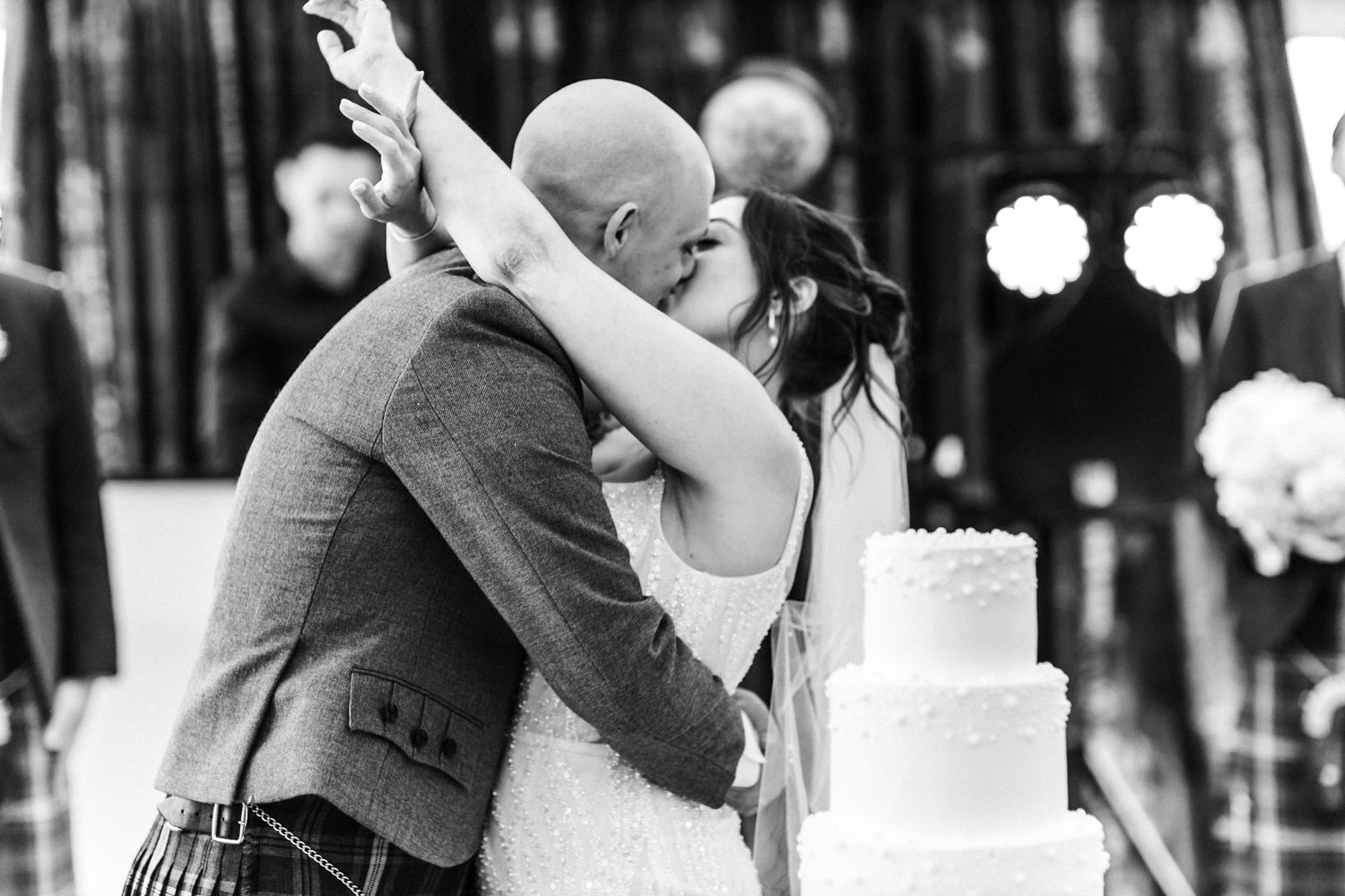 Bride and groom with wedding cake, kissing, wedding, Glass House Edinburgh City Scotland,